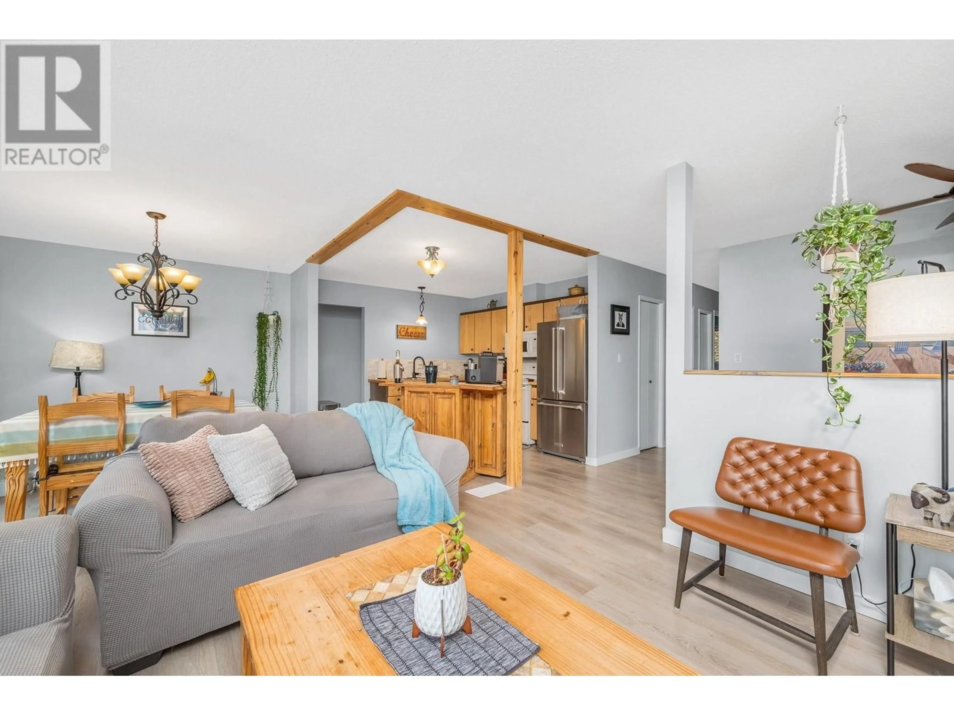 Living room with furniture, wood/laminate floor for 1007 33 AVENUE, Vernon British Columbia V1T6T6
