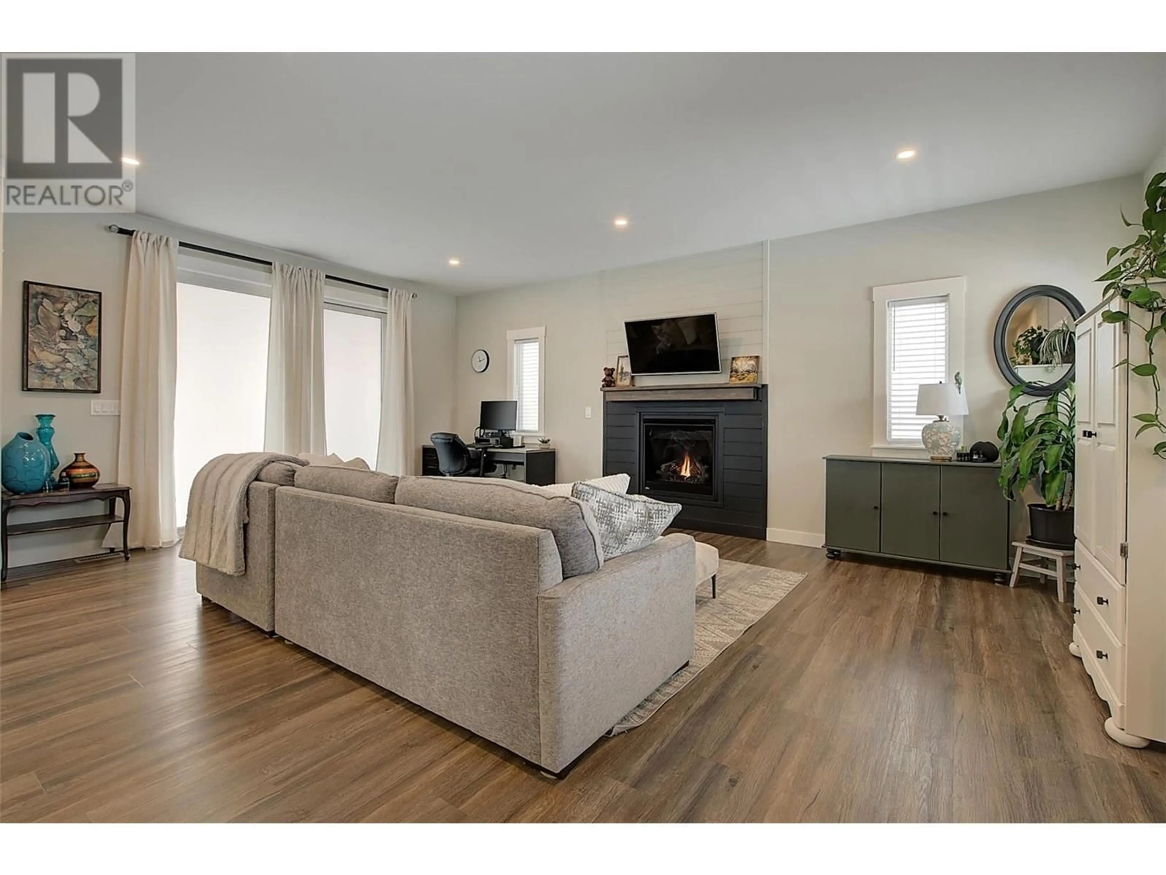 Living room with furniture, wood/laminate floor for 3704 INVERNESS ROAD, West Kelowna British Columbia V4T1J6