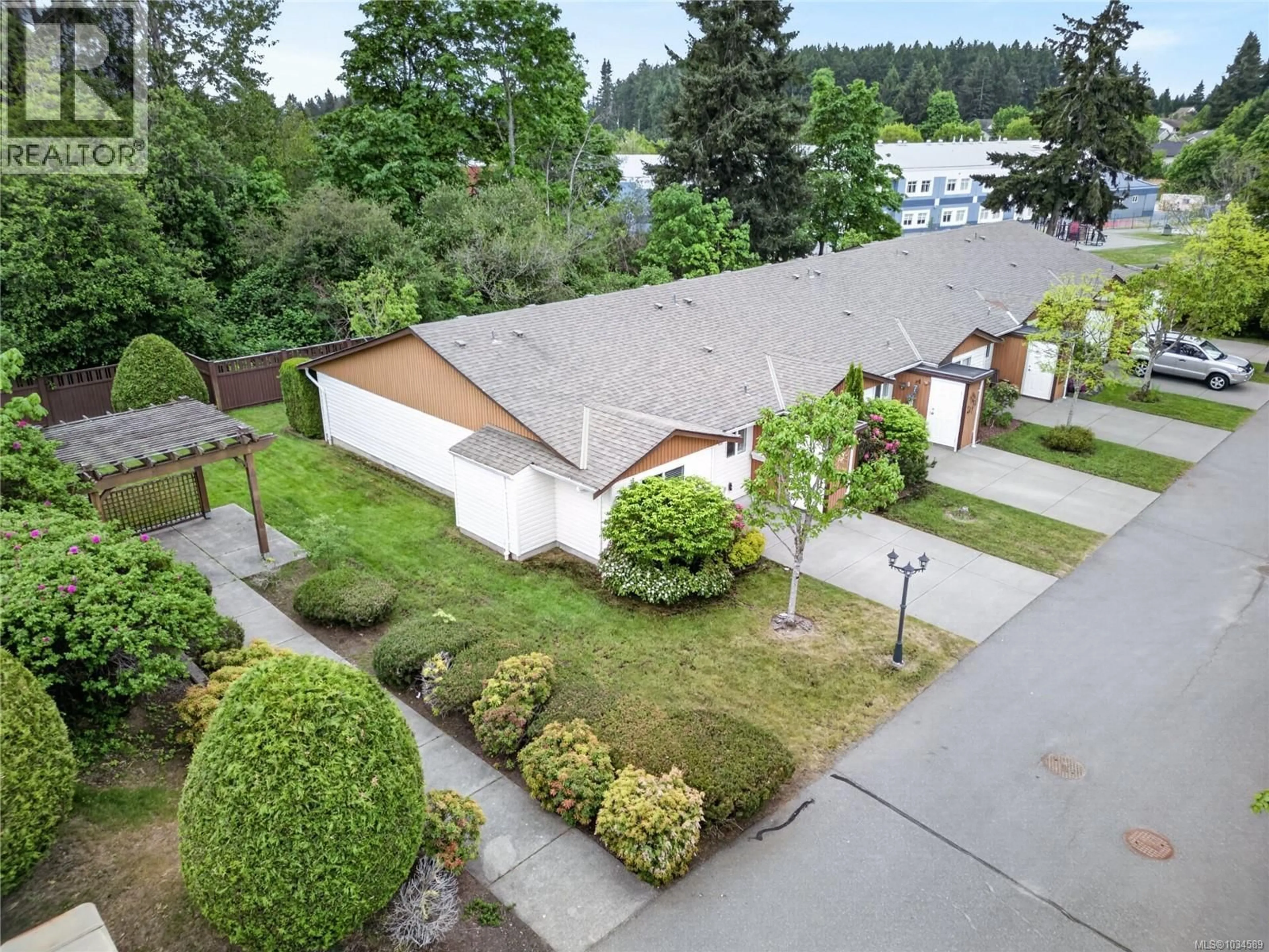 A pic from outside/outdoor area/front of a property/back of a property/a pic from drone, street for 18 - 2197 MURRELET DRIVE, Comox British Columbia V9M3Y1