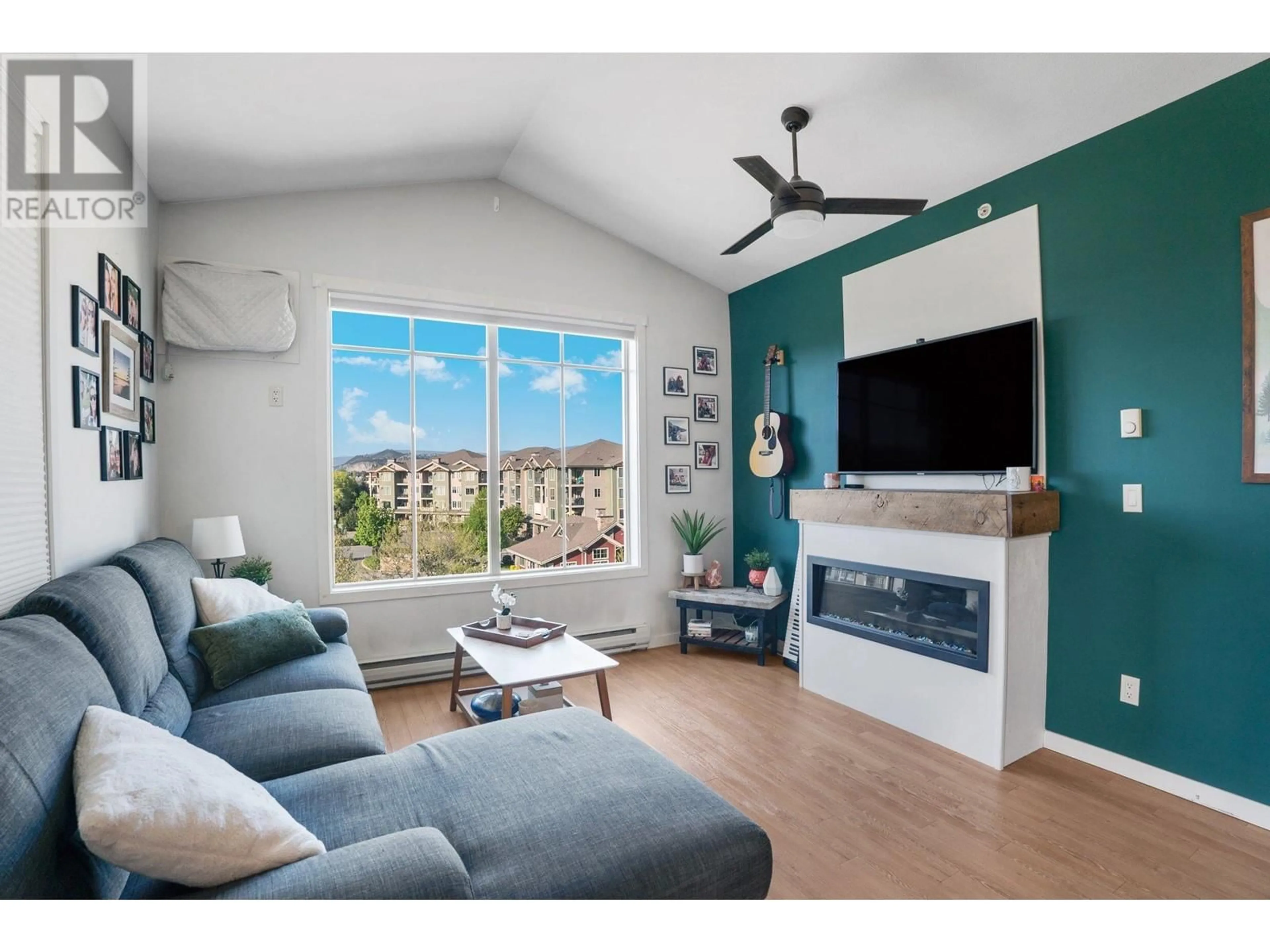 Living room with furniture, wood/laminate floor for 403 - 3739 CASORSO ROAD, Kelowna British Columbia V1W5E8
