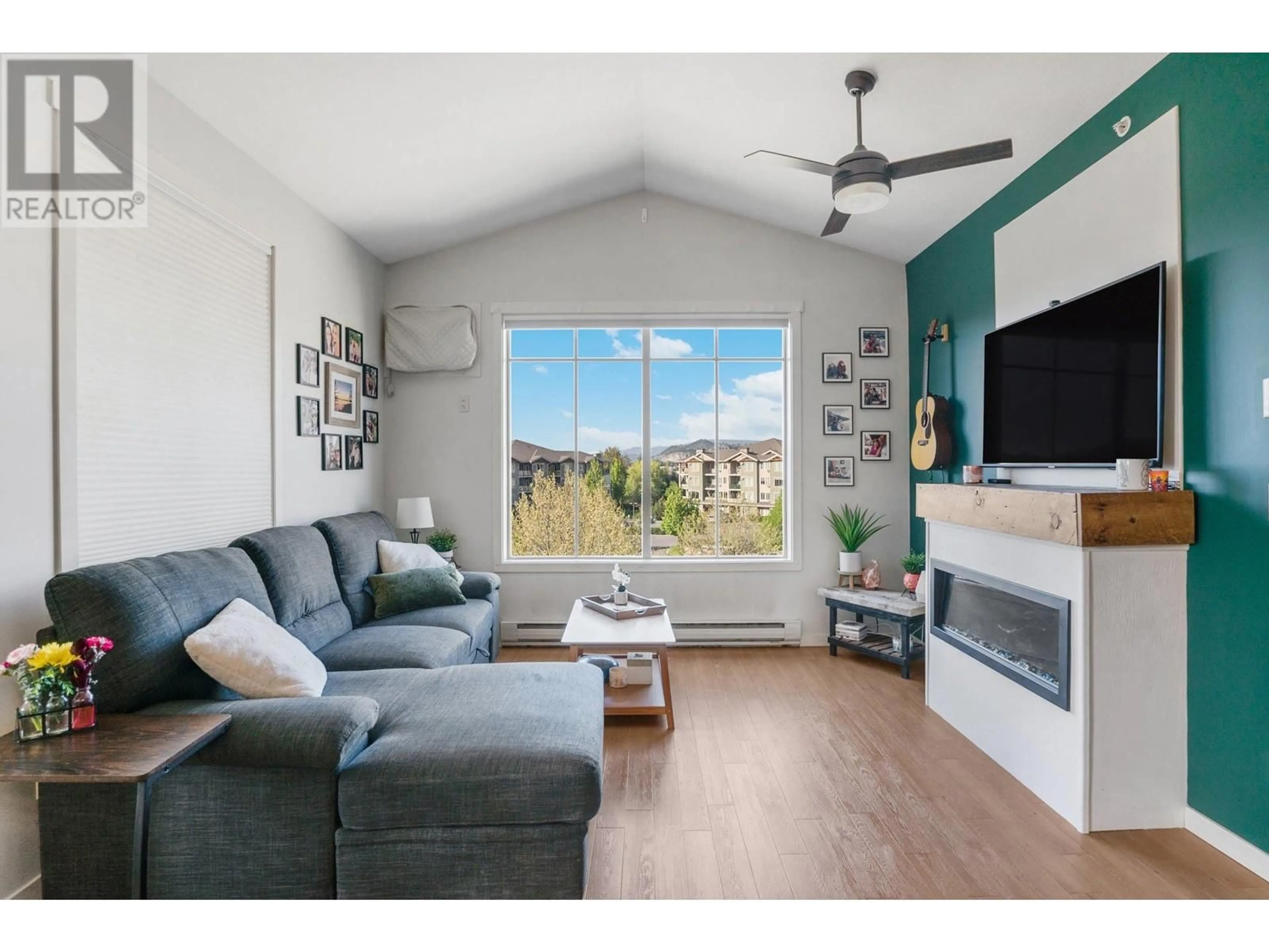 Living room with furniture, wood/laminate floor for 403 - 3739 CASORSO ROAD, Kelowna British Columbia V1W5E8
