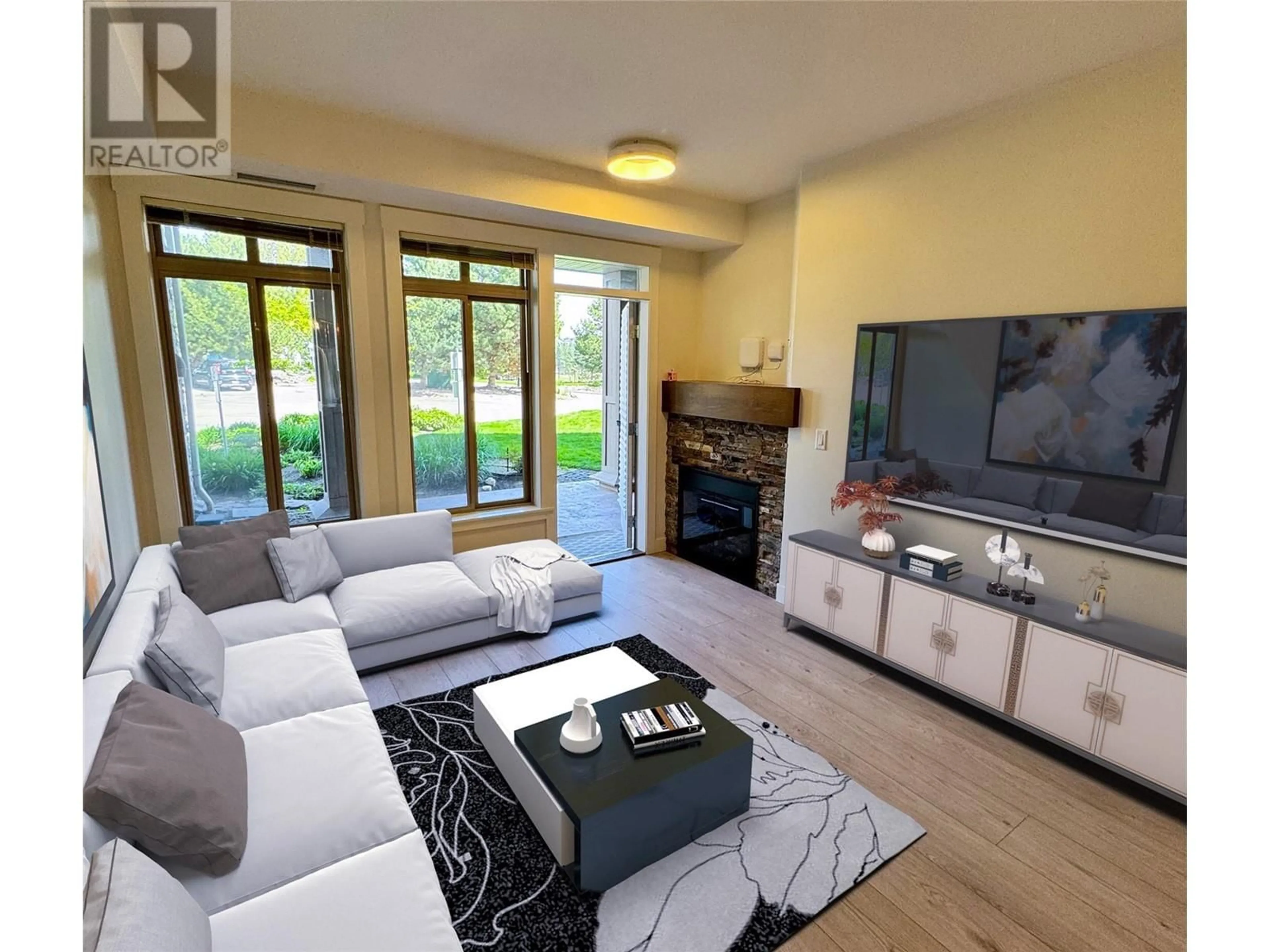 Living room with furniture, wood/laminate floor for 102 - 3533 CARRINGTON ROAD, West Kelowna British Columbia V4T2Z9