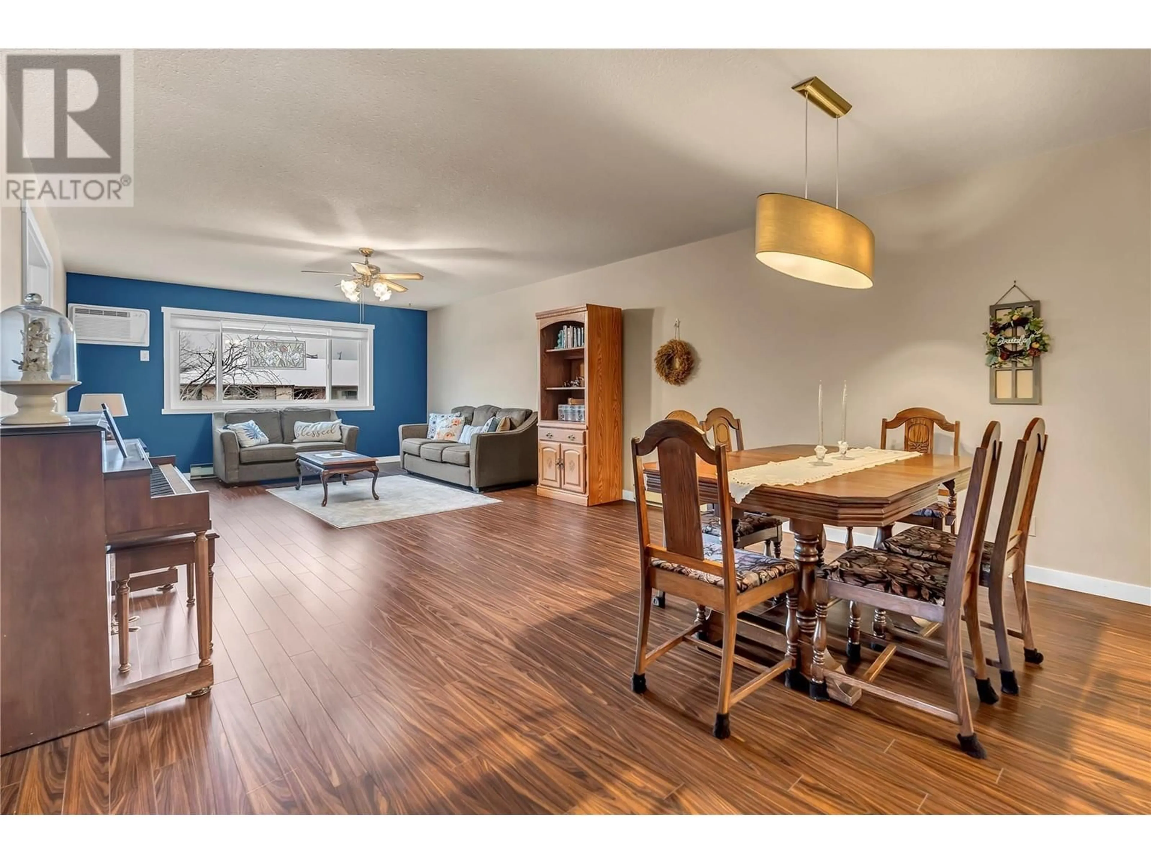 Living room with furniture, wood/laminate floor for 207 - 1820 ATKINSON STREET, Penticton British Columbia V2A7M6