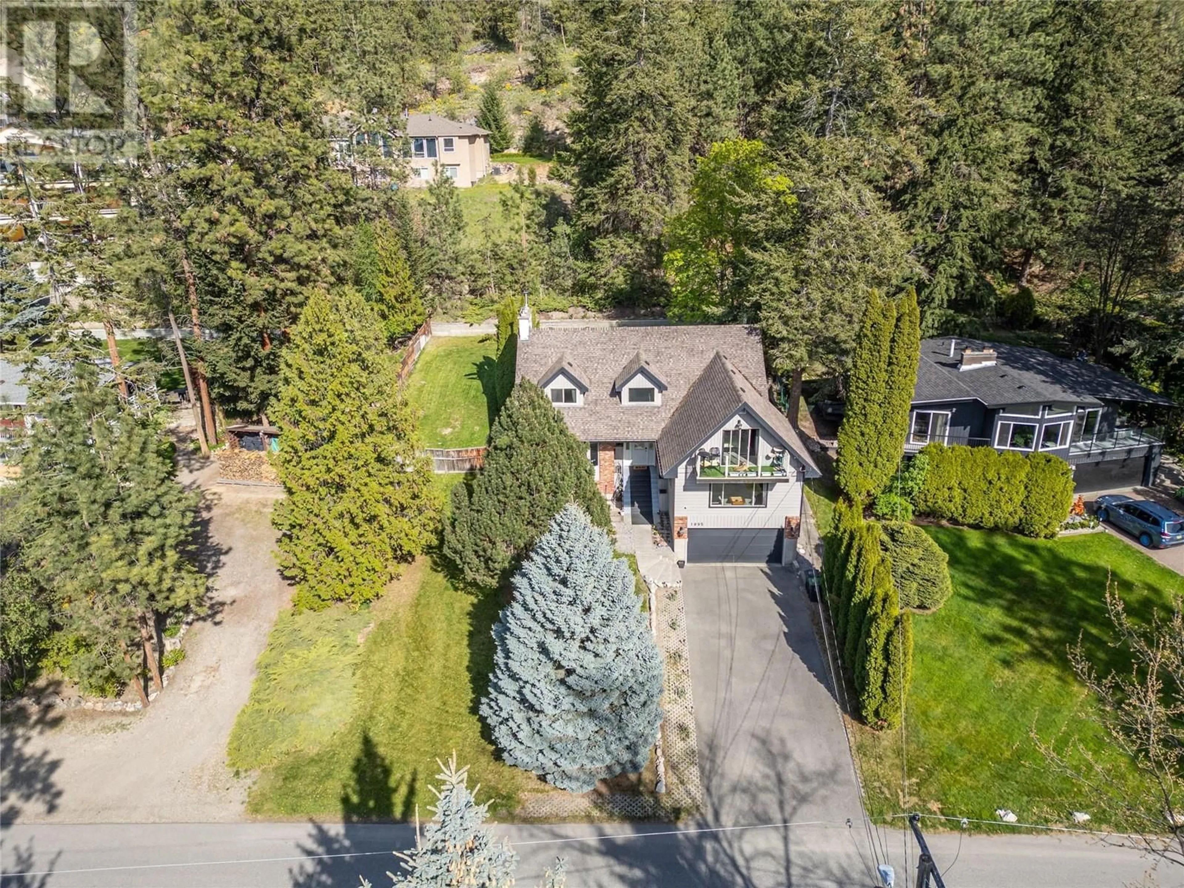 A pic from outside/outdoor area/front of a property/back of a property/a pic from drone, street for 1095 TOOVEY ROAD, Kelowna British Columbia V1X6R2