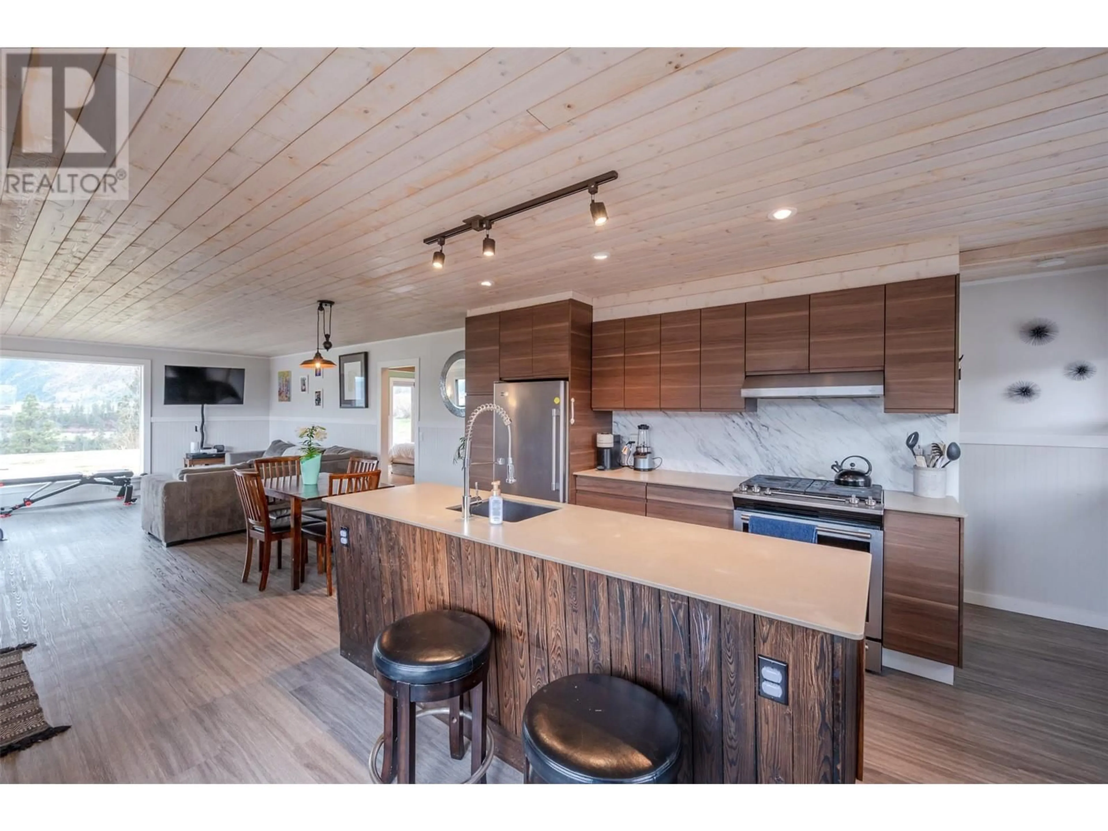 Open concept kitchen, wood/laminate floor for 3909 GARTRELL ROAD, Summerland British Columbia V0H1Z4