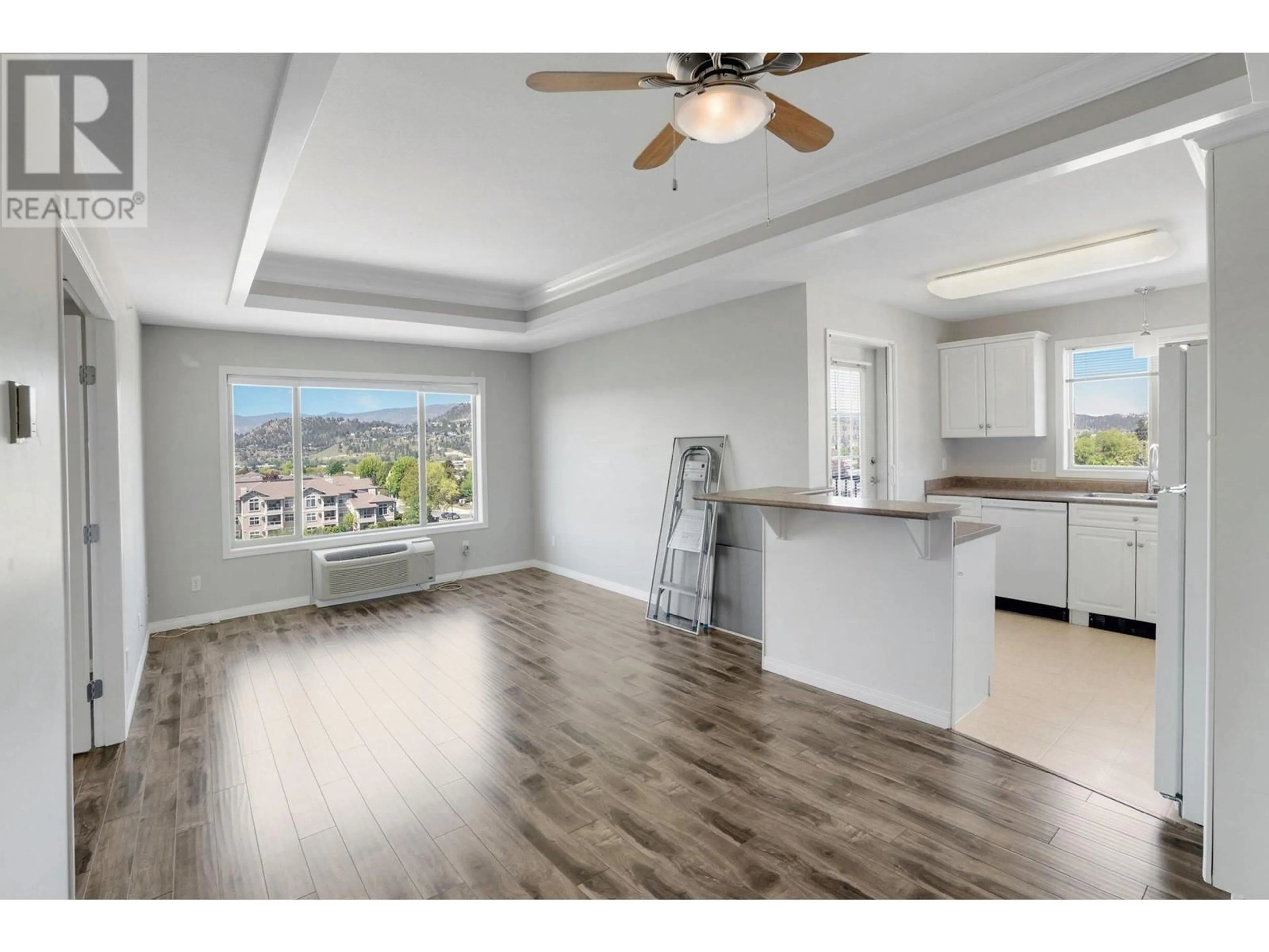 Open concept kitchen, wood/laminate floor for 402 - 265 FROELICH ROAD, Kelowna British Columbia V1X3M6