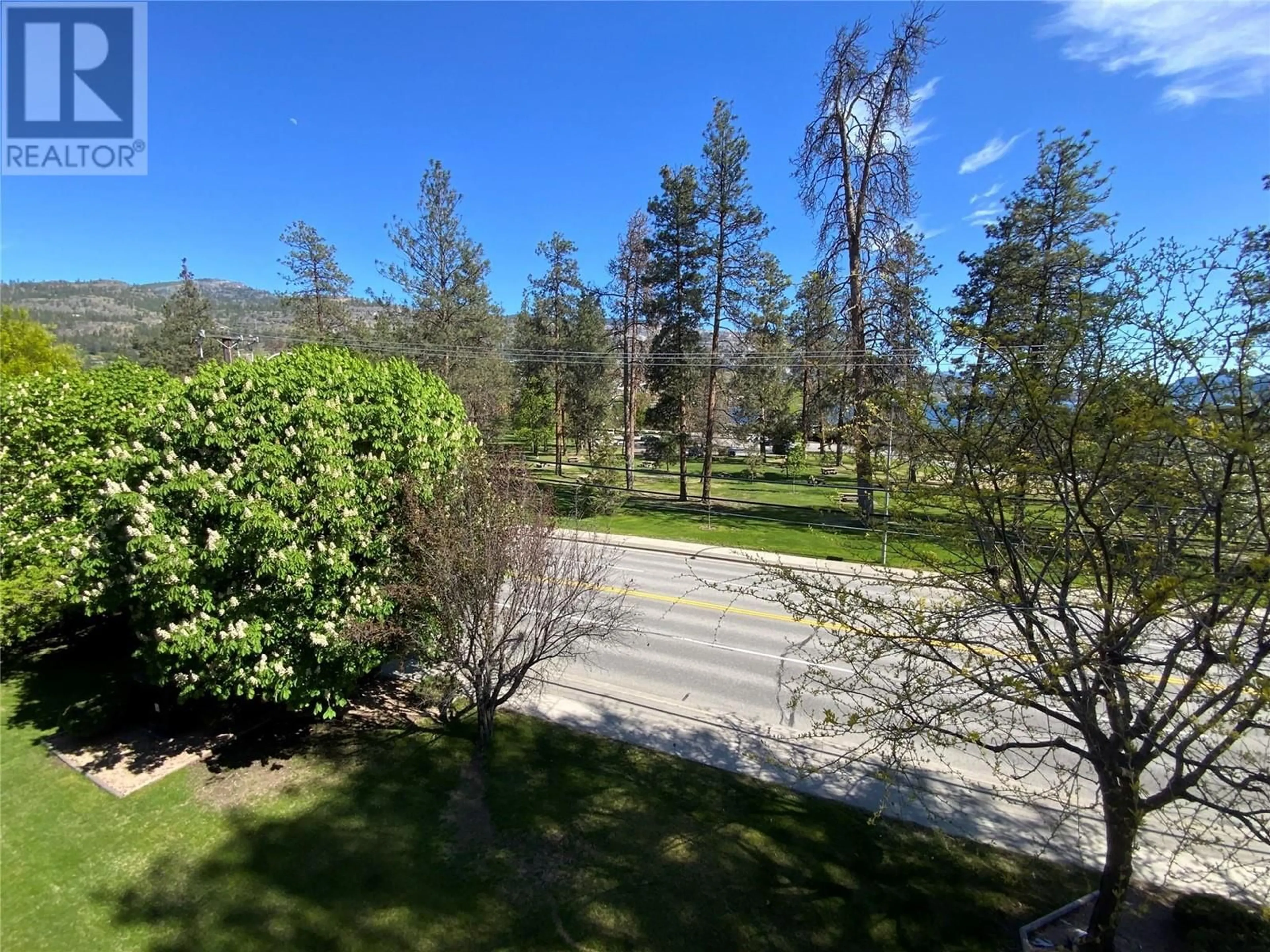 A pic from outside/outdoor area/front of a property/back of a property/a pic from drone, forest/trees view for 401 - 110 SKAHA PLACE, Penticton British Columbia V2A7L1
