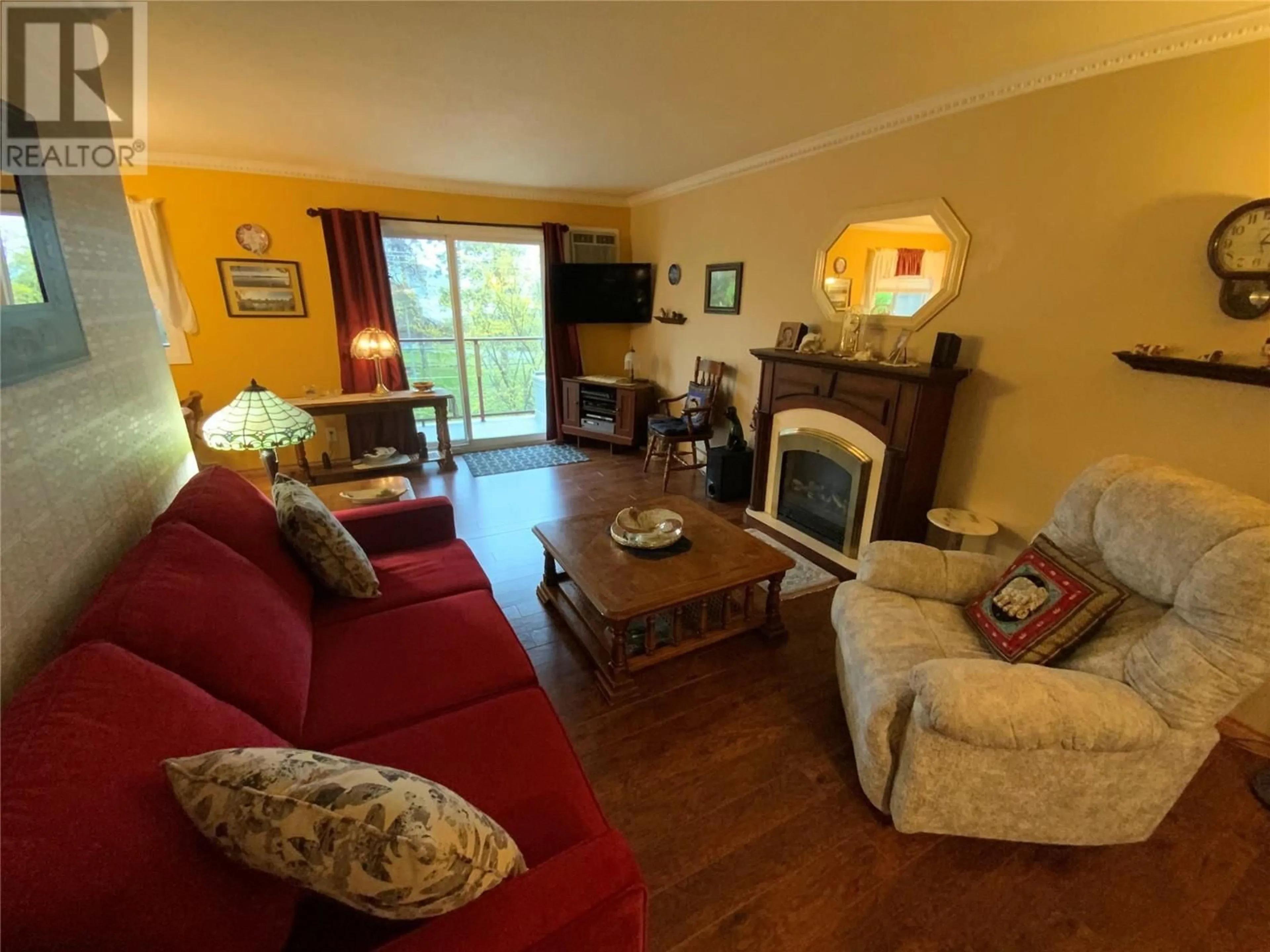 Living room with furniture, wood/laminate floor for 401 - 110 SKAHA PLACE, Penticton British Columbia V2A7L1