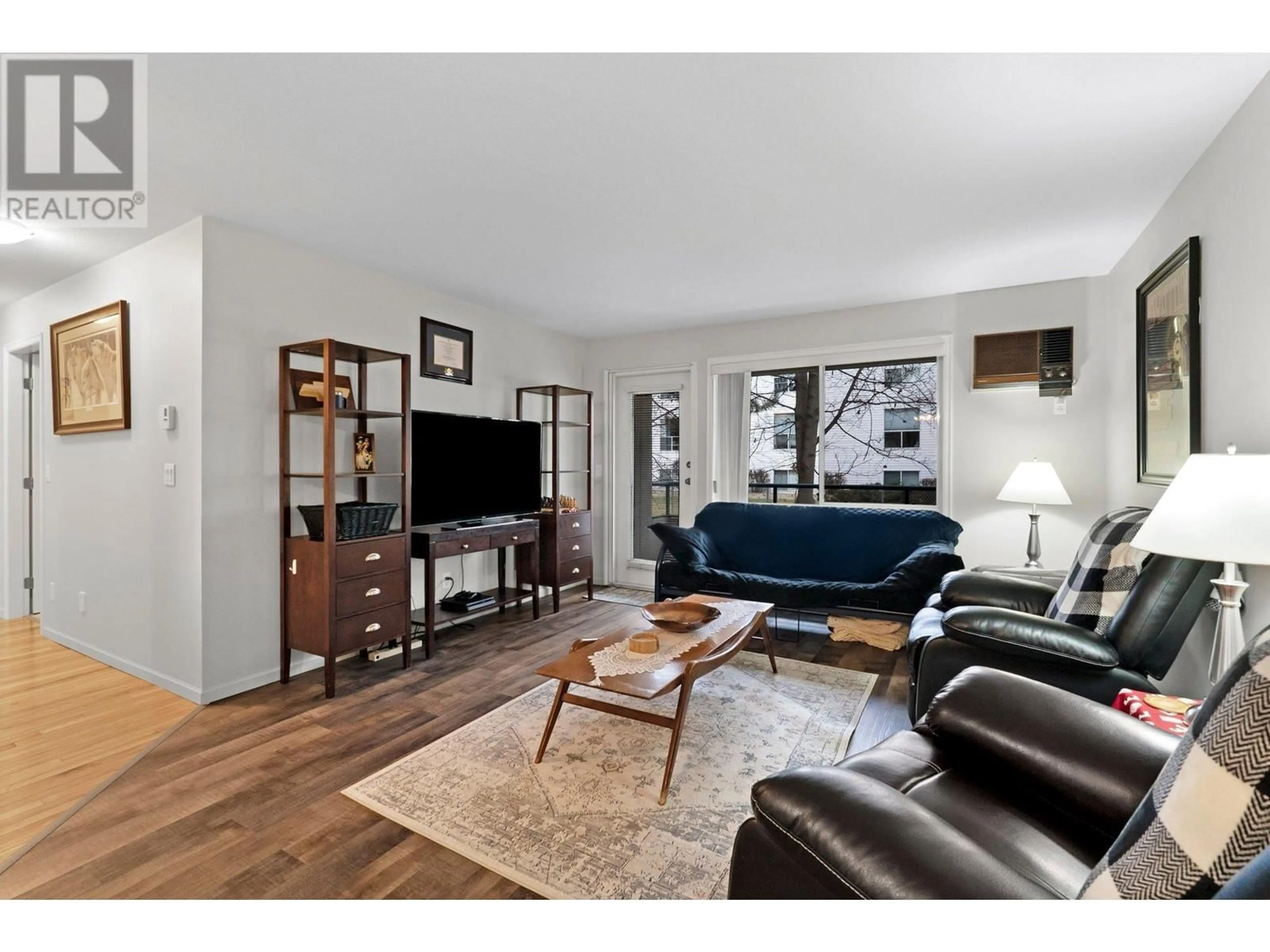 Living room with furniture, wood/laminate floor for 211 - 730 BADKE ROAD, Kelowna British Columbia V1X6G9