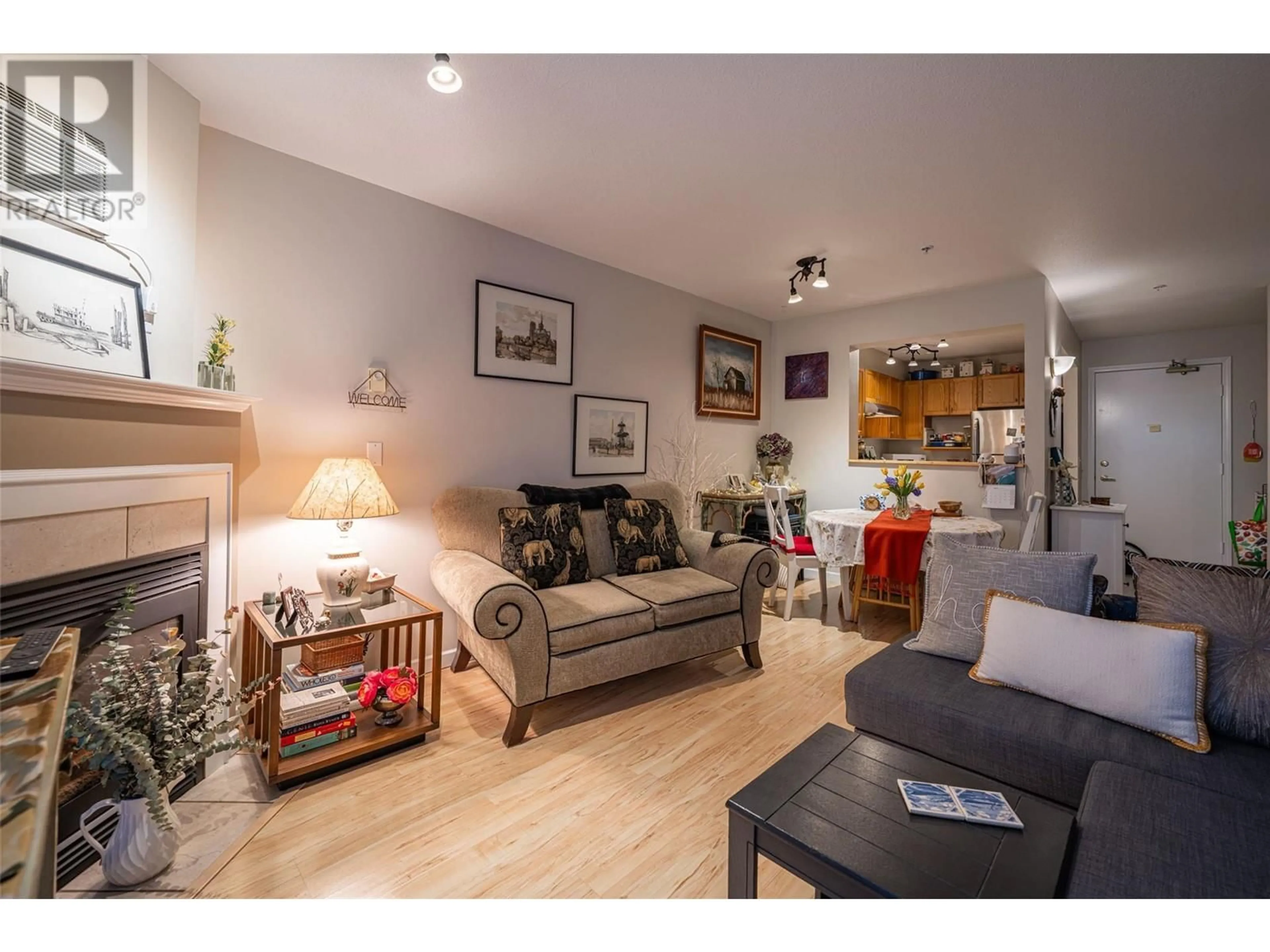 Living room with furniture, wood/laminate floor for 206 - 3320 CENTENNIAL DRIVE, Vernon British Columbia V1T9M4