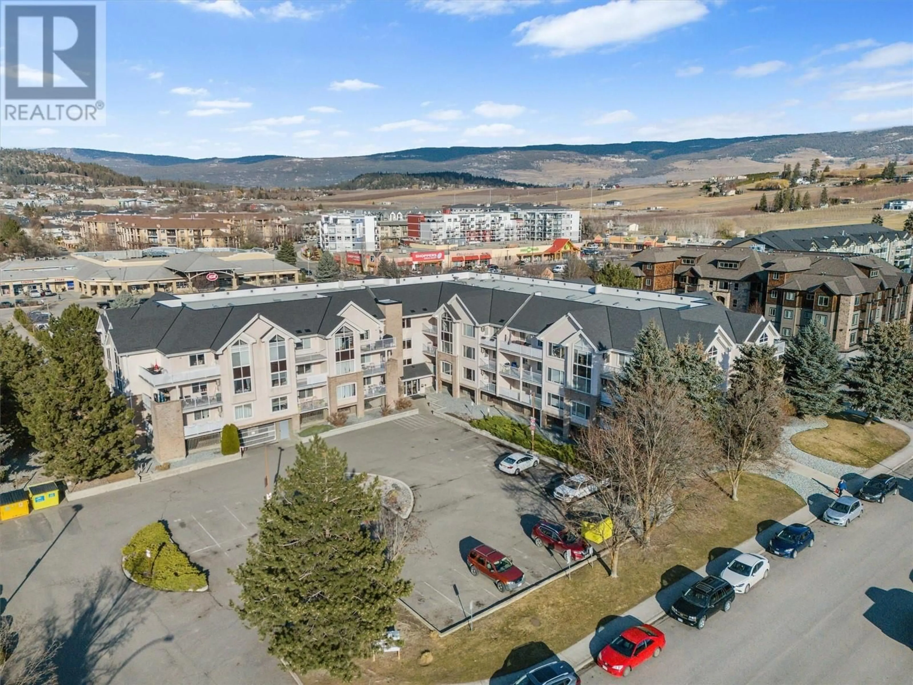 A pic from outside/outdoor area/front of a property/back of a property/a pic from drone, mountain view for 205 - 400 SUTTON CRESCENT, Kelowna British Columbia V1V2A5