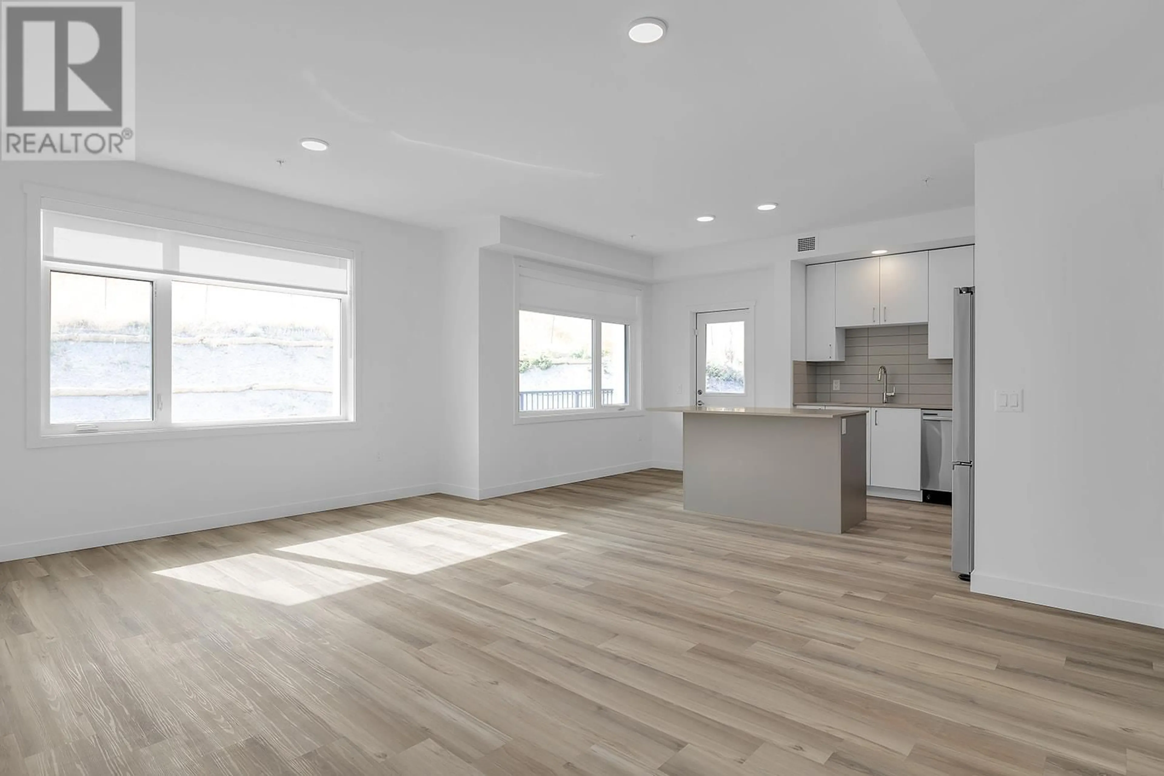 Open concept kitchen, wood/laminate floor for 318 - 1057 FROST ROAD, Kelowna British Columbia V1W0G7