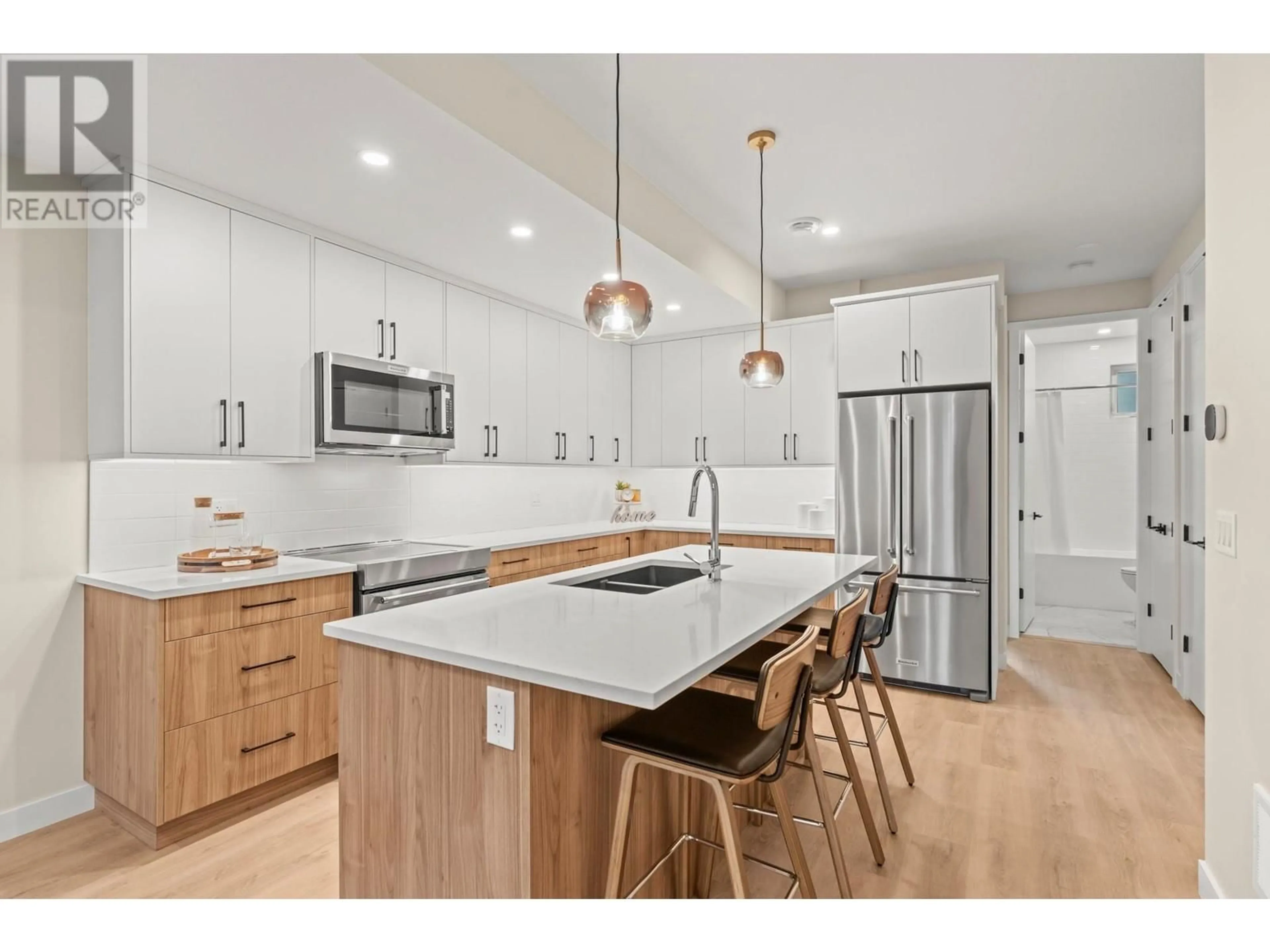 Open concept kitchen, wood/laminate floor for 2 - 3907 26 STREET, Vernon British Columbia V1T4V5
