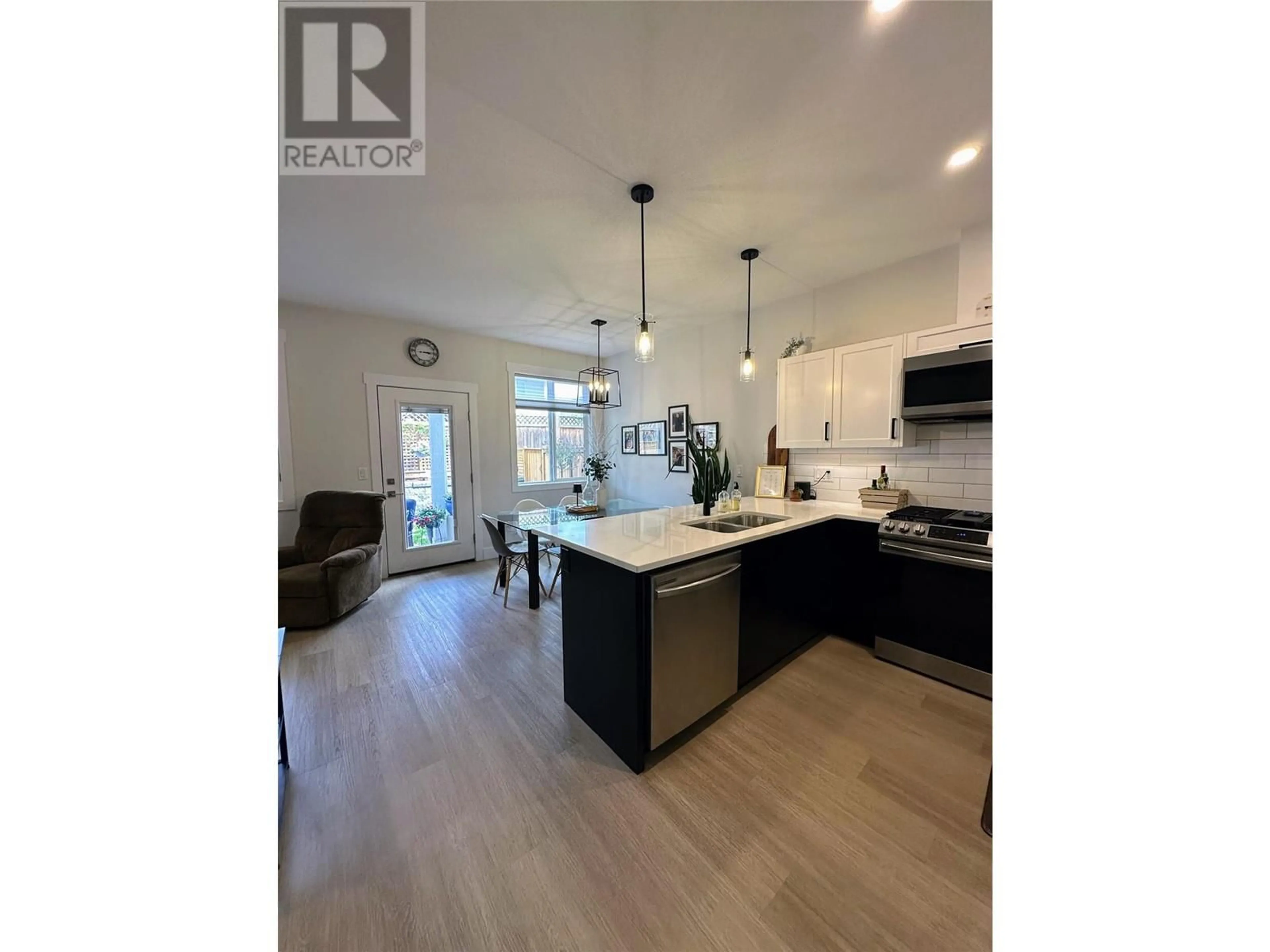 Open concept kitchen, wood/laminate floor for 7 - 1999 15 AVENUE, Vernon British Columbia V1T9R4