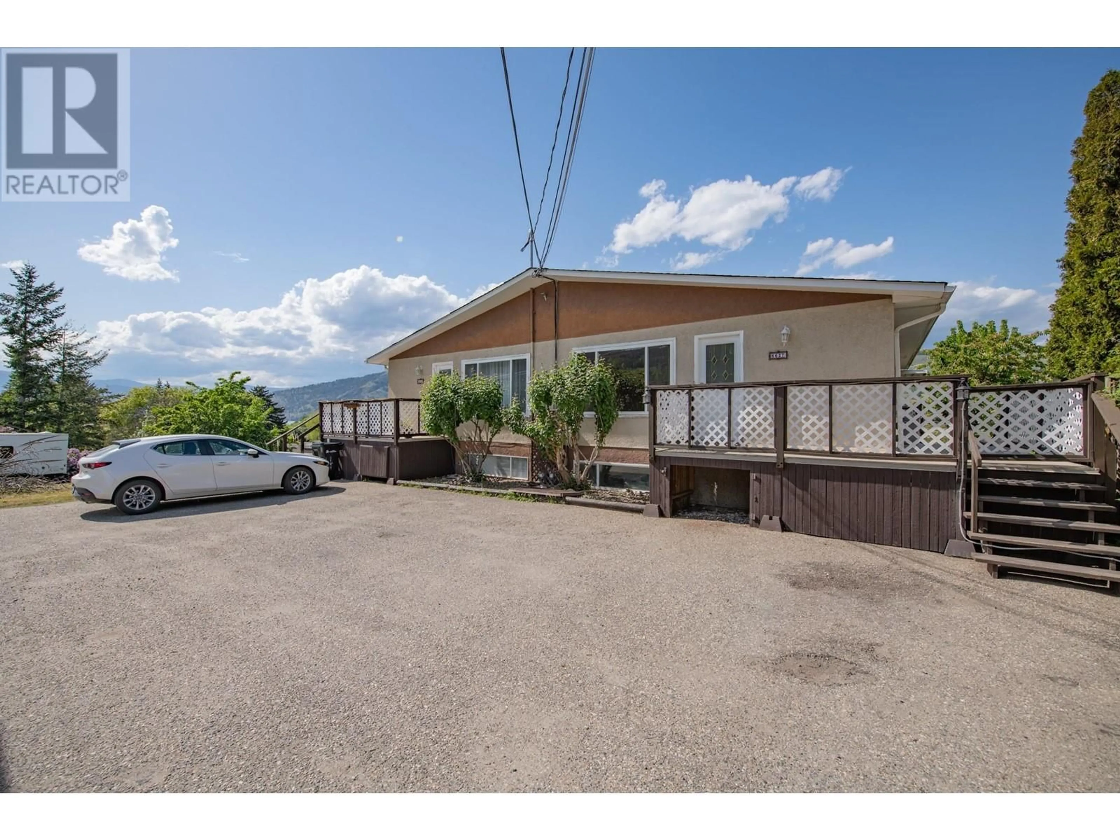 A pic from outside/outdoor area/front of a property/back of a property/a pic from drone, street for 6627 LONGACRE DRIVE, Vernon British Columbia V1H1H9