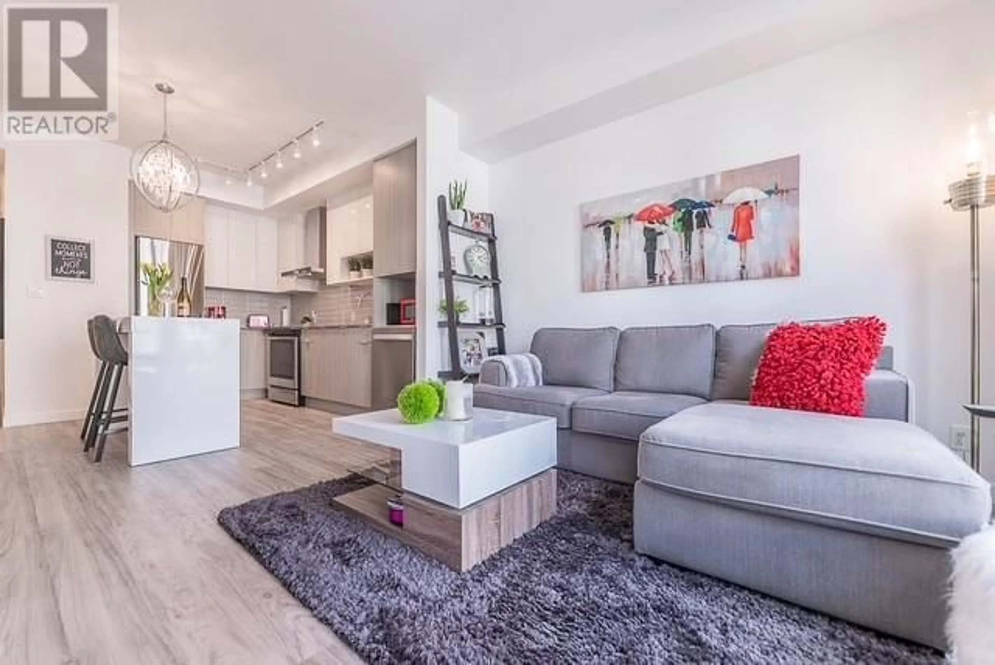 Living room with furniture, wood/laminate floor for 210 - 1775 CHAPMAN PLACE, Kelowna British Columbia V1Y0G3