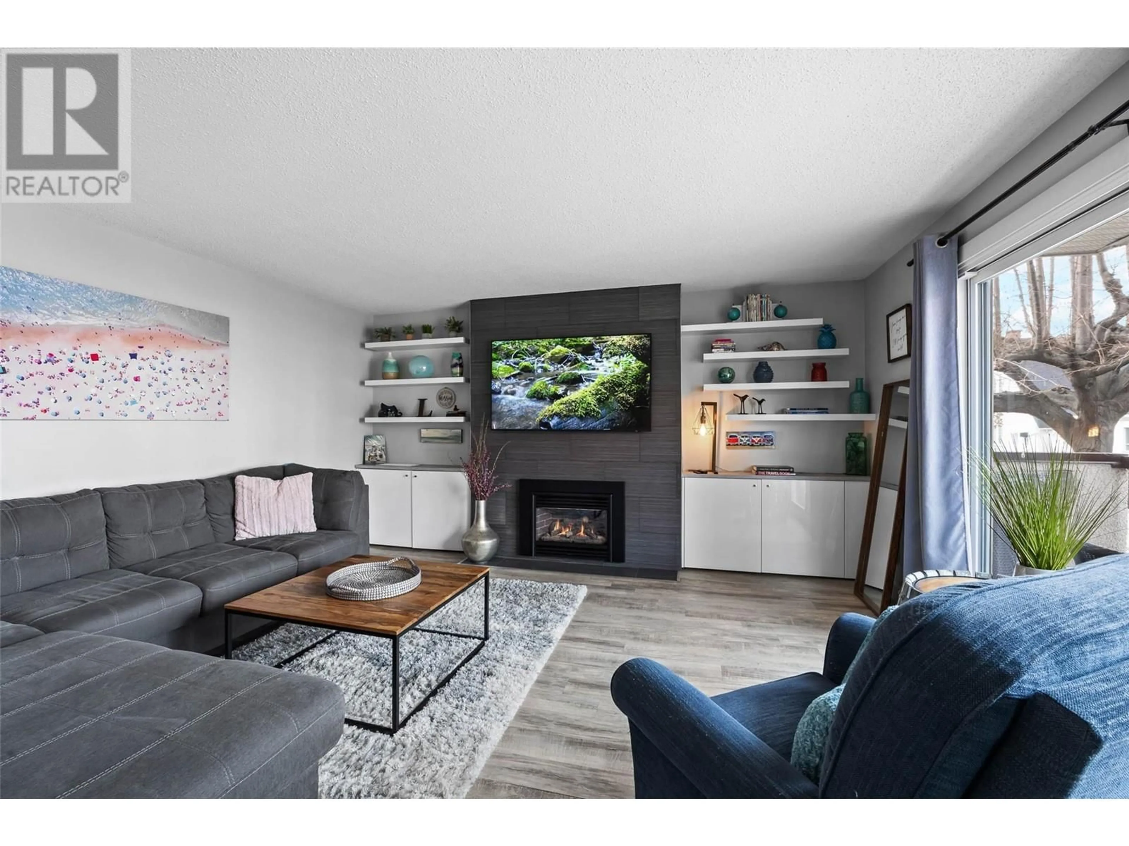 Living room with furniture, wood/laminate floor for 102 - 411 NICOLA STREET, Kamloops British Columbia V2C2P7