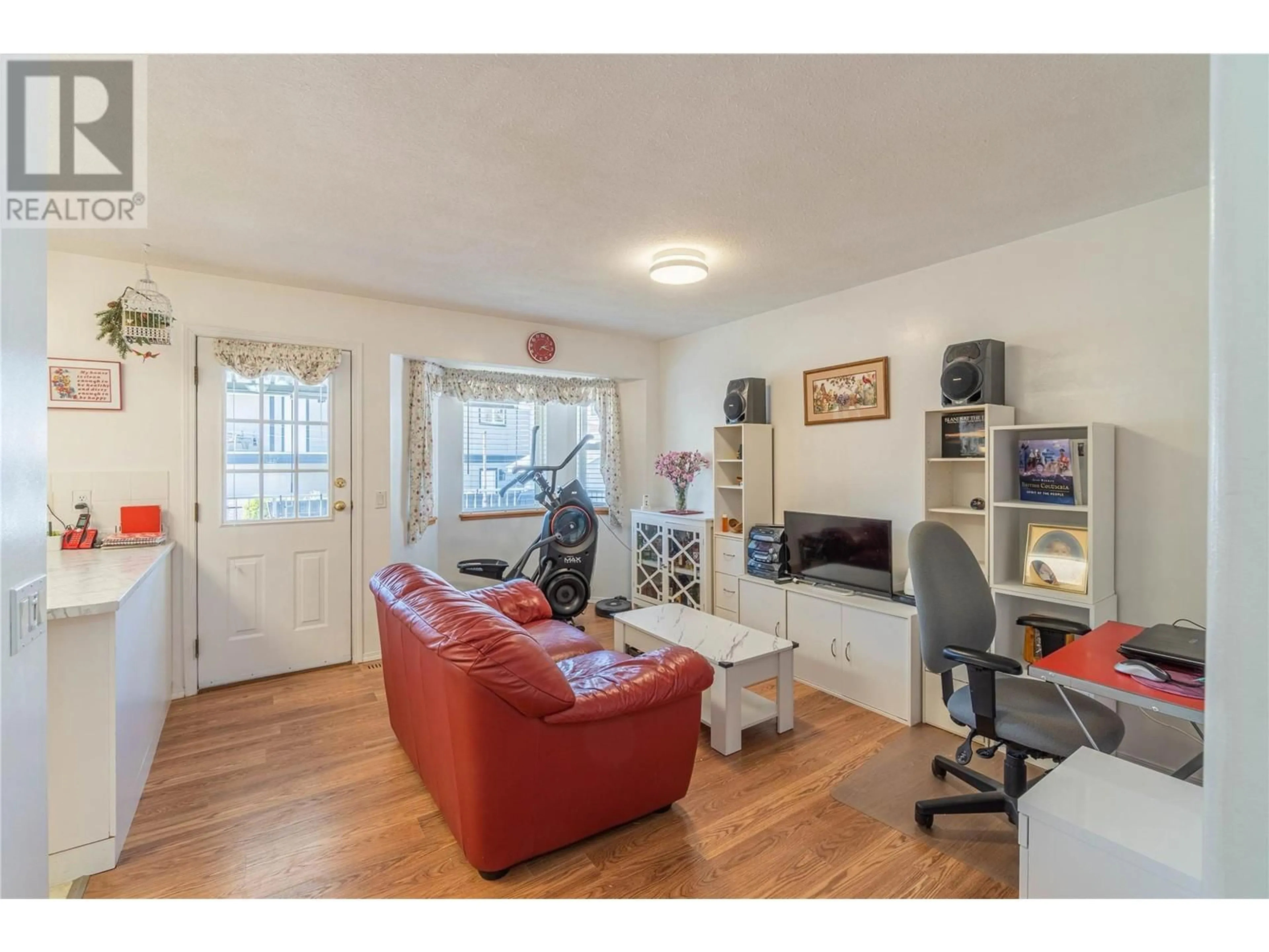 Living room with furniture, wood/laminate floor for 2044 MONTEITH DRIVE, Kamloops British Columbia V2E2G5