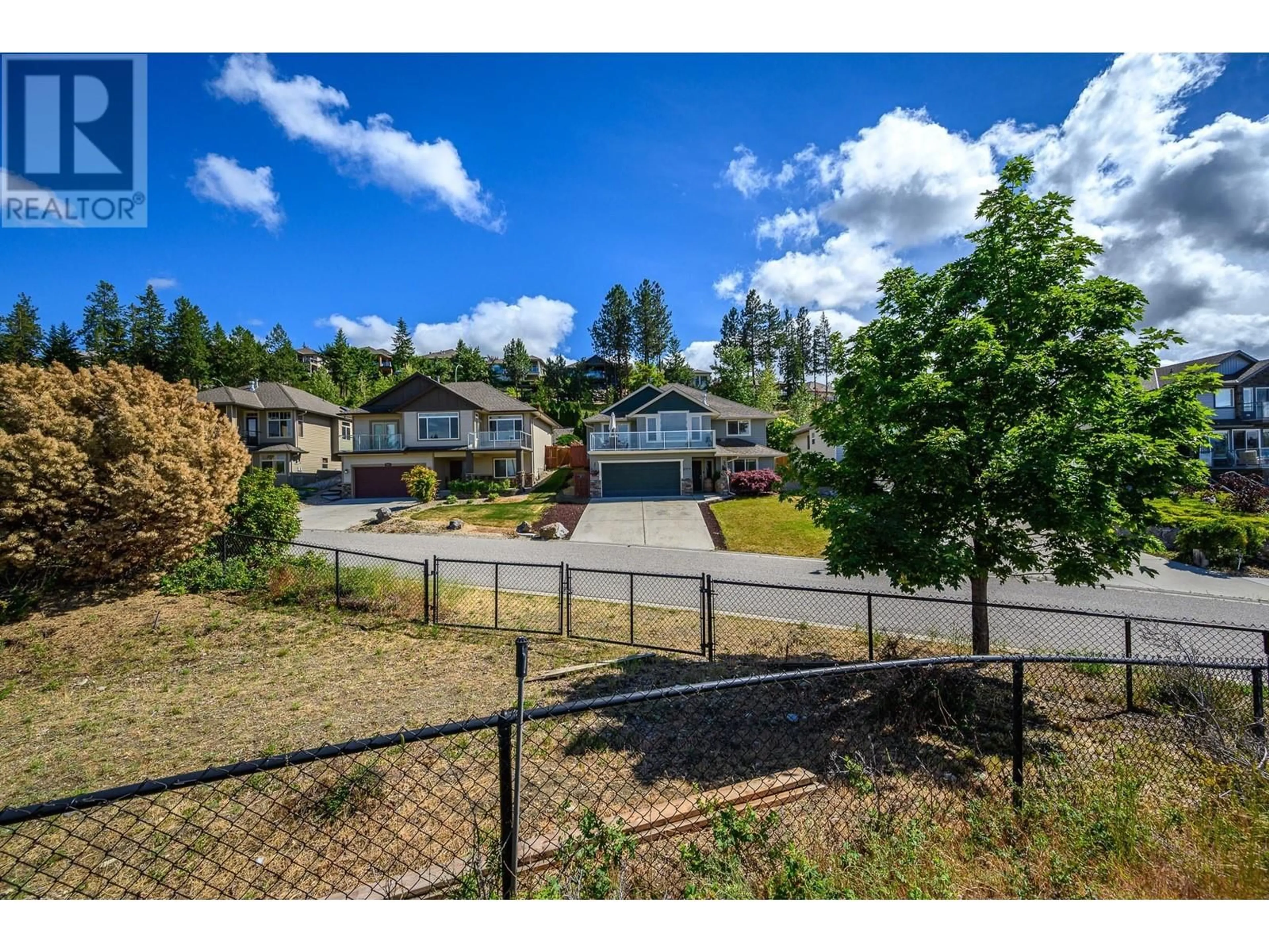 A pic from outside/outdoor area/front of a property/back of a property/a pic from drone, mountain view for 4979 WINDSONG CRESCENT, Kelowna British Columbia V1W5C4