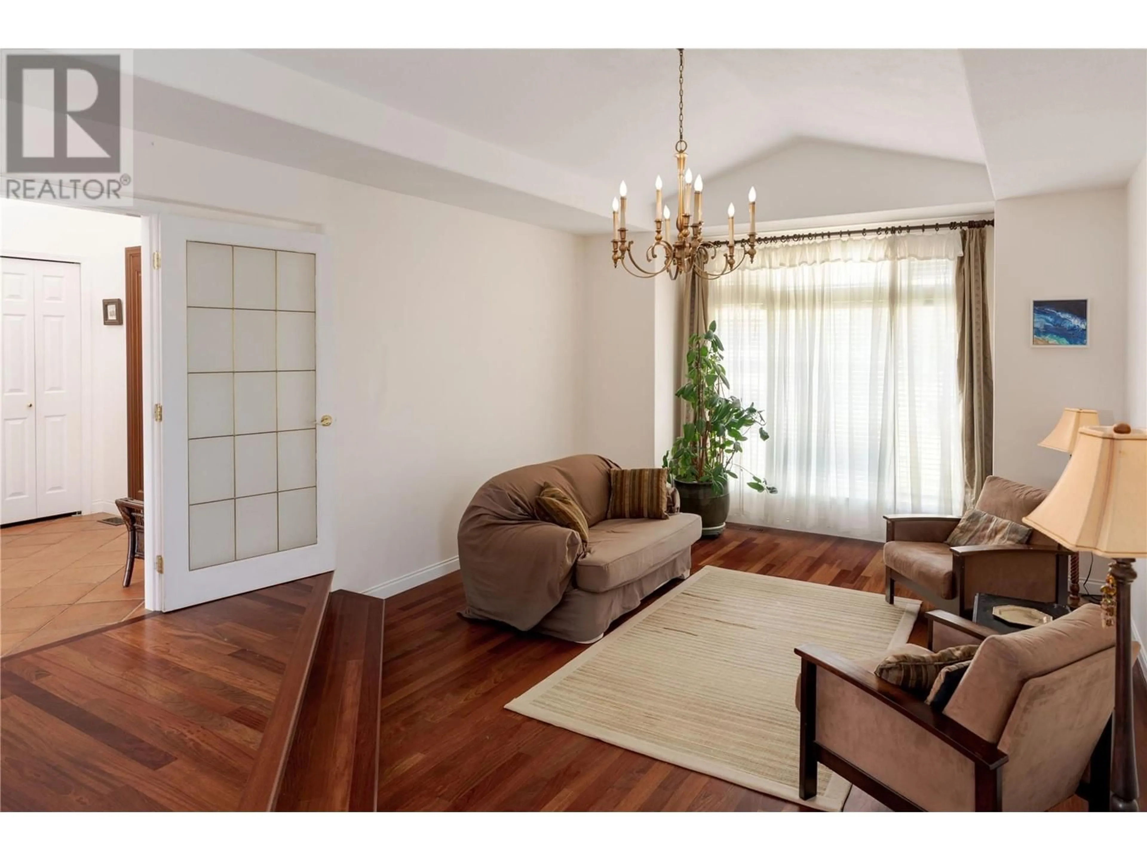Living room with furniture, wood/laminate floor for 740 ROYAL PINE DRIVE, Kelowna British Columbia V1Y9G2