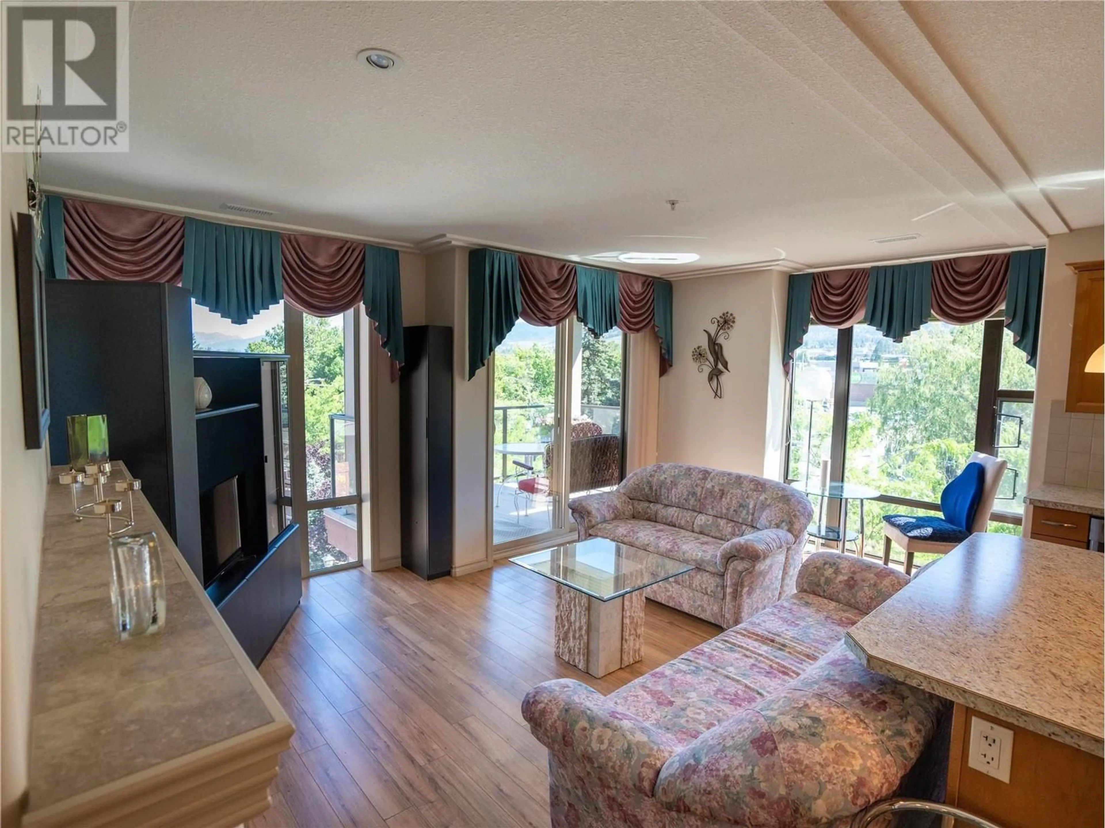 Living room with furniture, wood/laminate floor for 402 - 2125 ATKINSON STREET, Penticton British Columbia V2A9E6