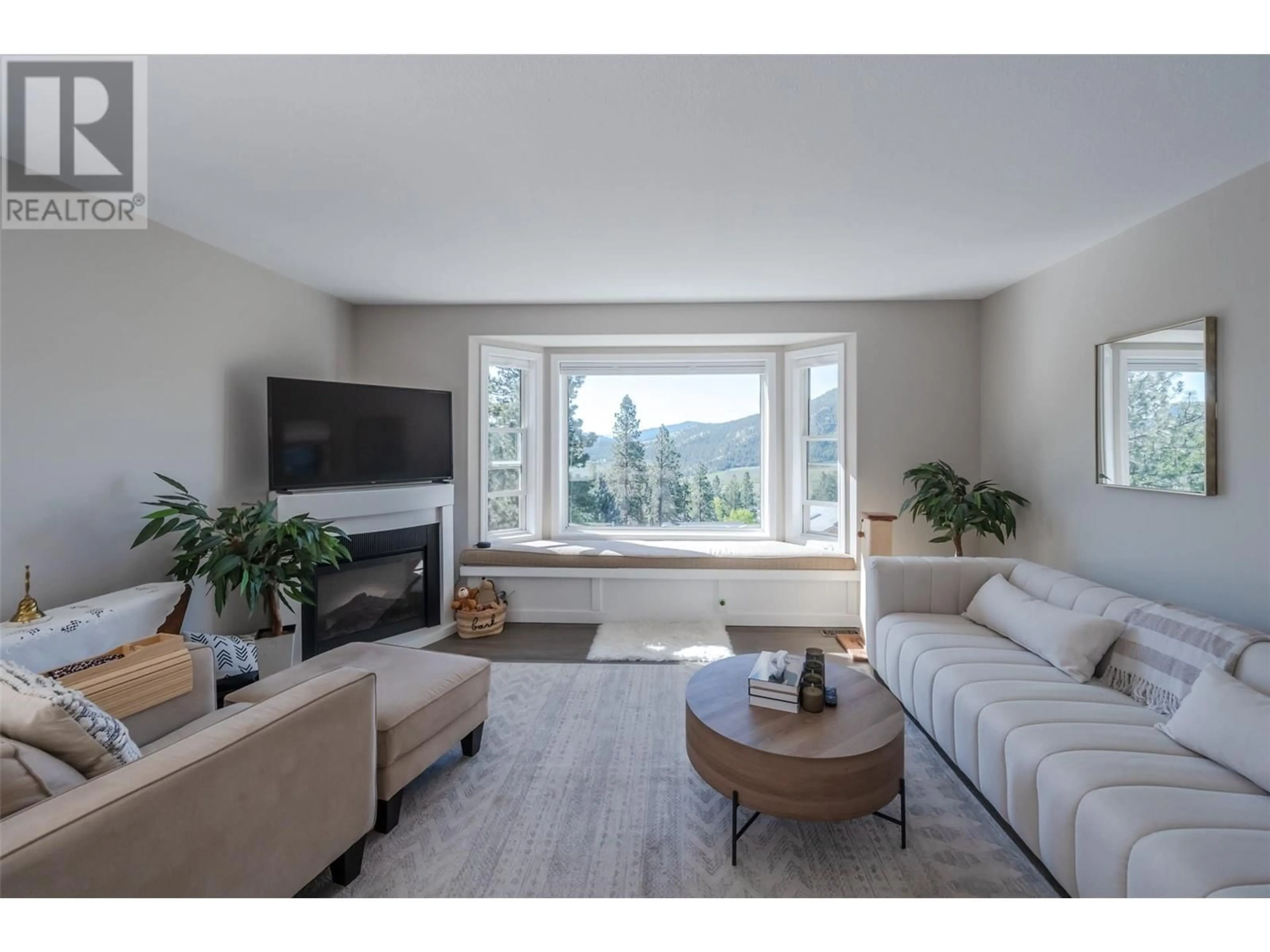 Living room with furniture, wood/laminate floor for 13424 HERMISTON DRIVE, Summerland British Columbia V0H1Z8