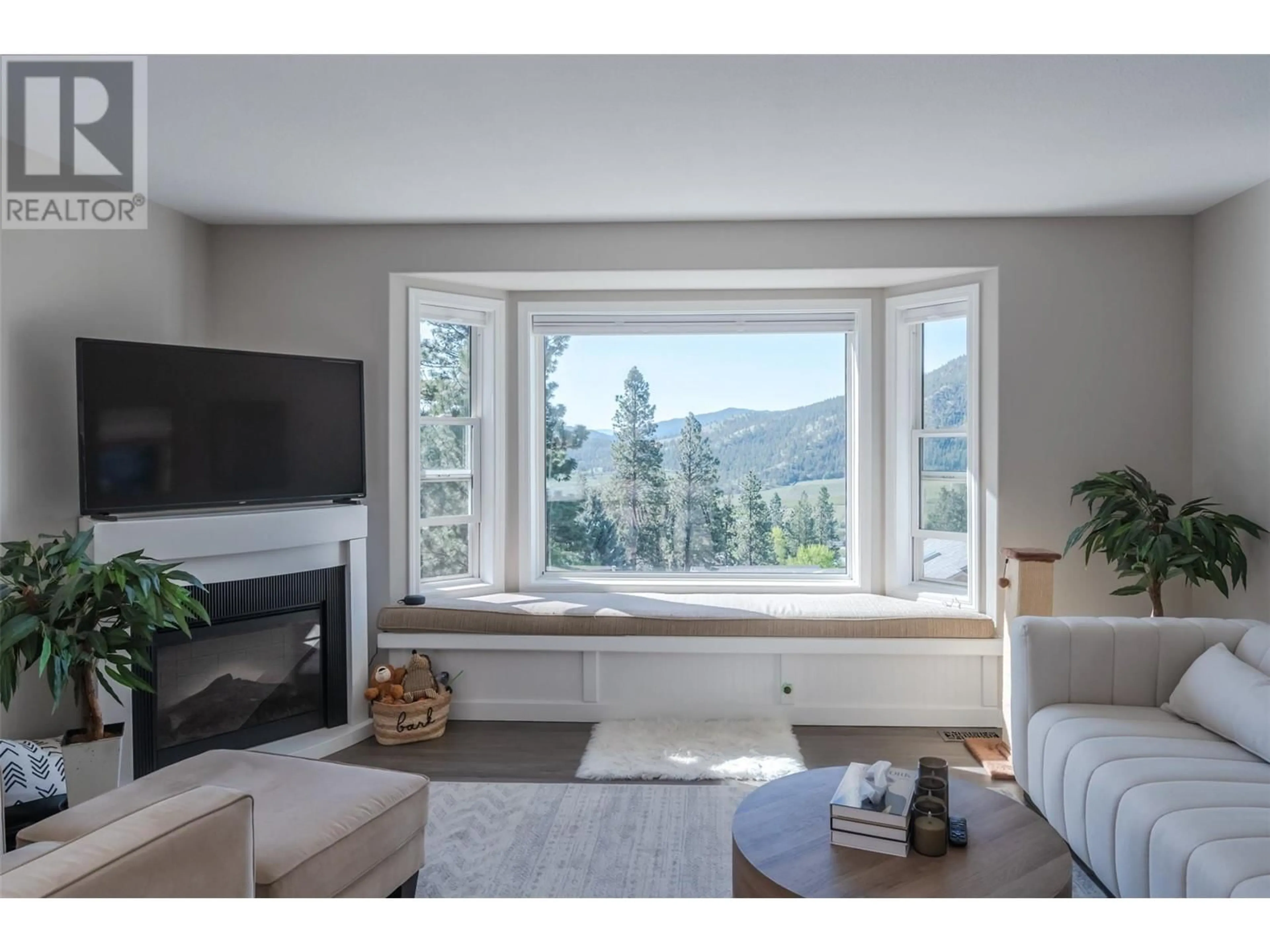 Living room with furniture, wood/laminate floor for 13424 HERMISTON DRIVE, Summerland British Columbia V0H1Z8