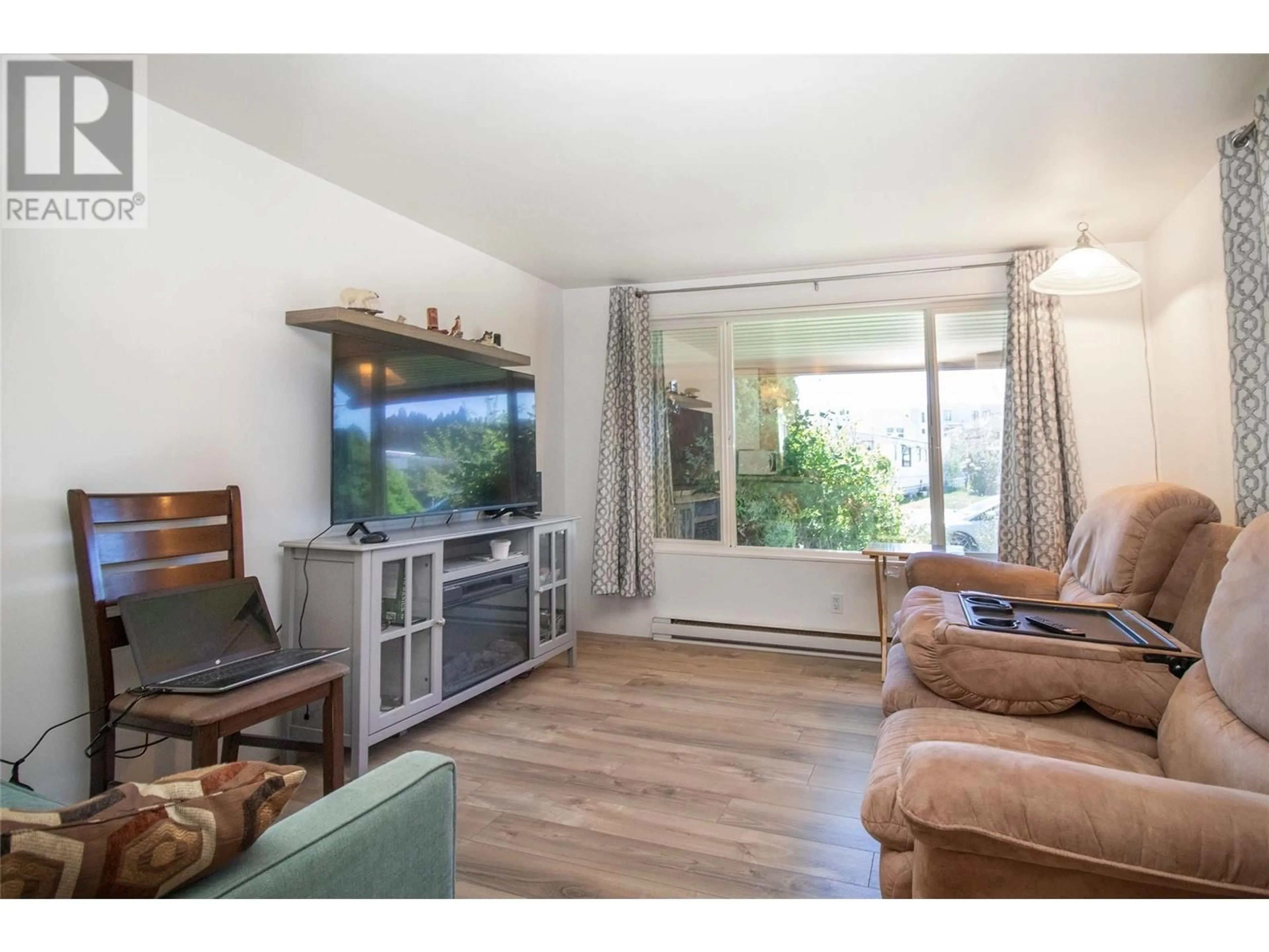 Living room with furniture, wood/laminate floor for 92 - 3745 LAKESHORE ROAD, Kelowna British Columbia V1W3K4