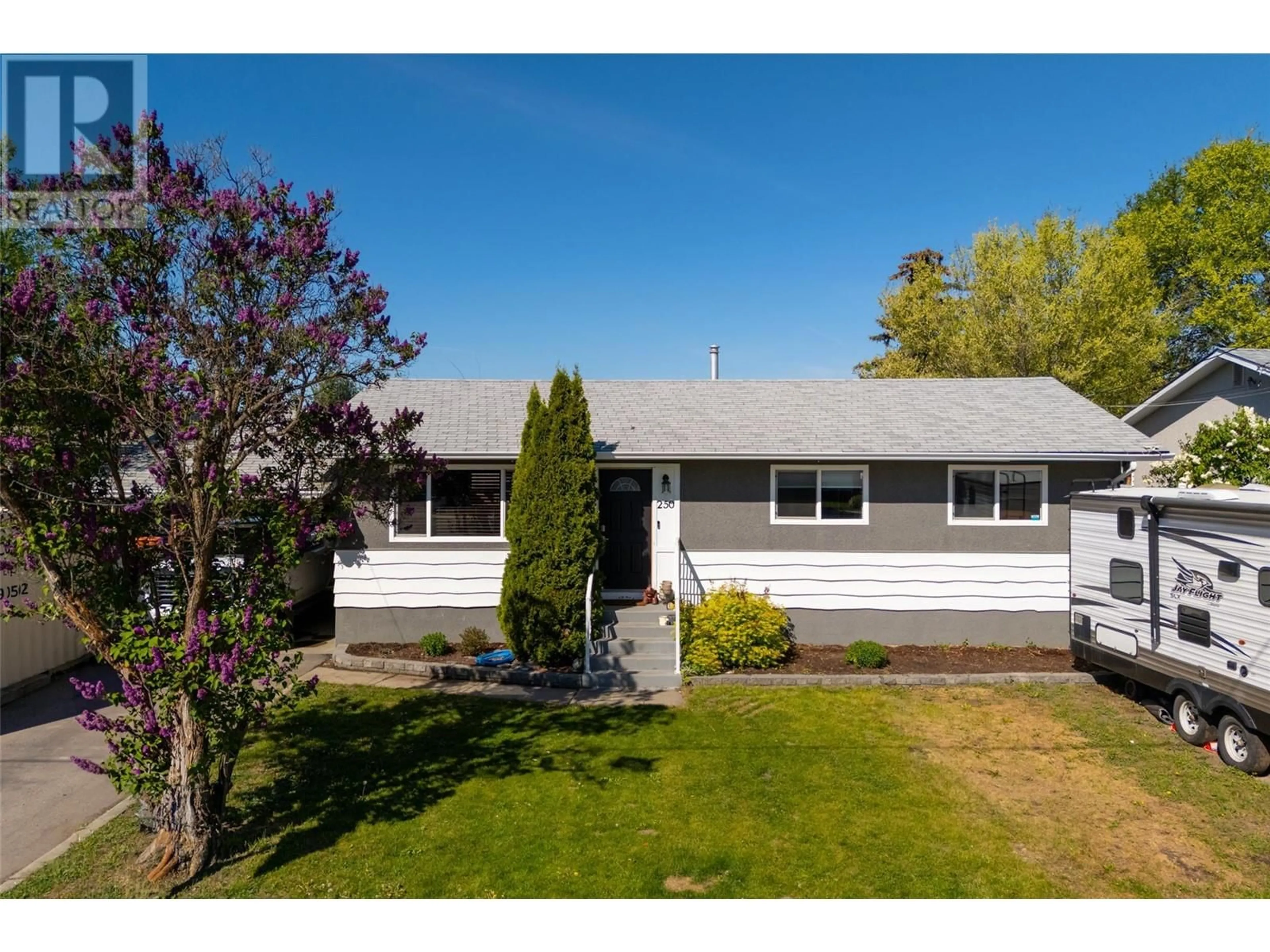 Home with vinyl exterior material, street for 250 DUNDAS ROAD, Kelowna British Columbia V1X3X7