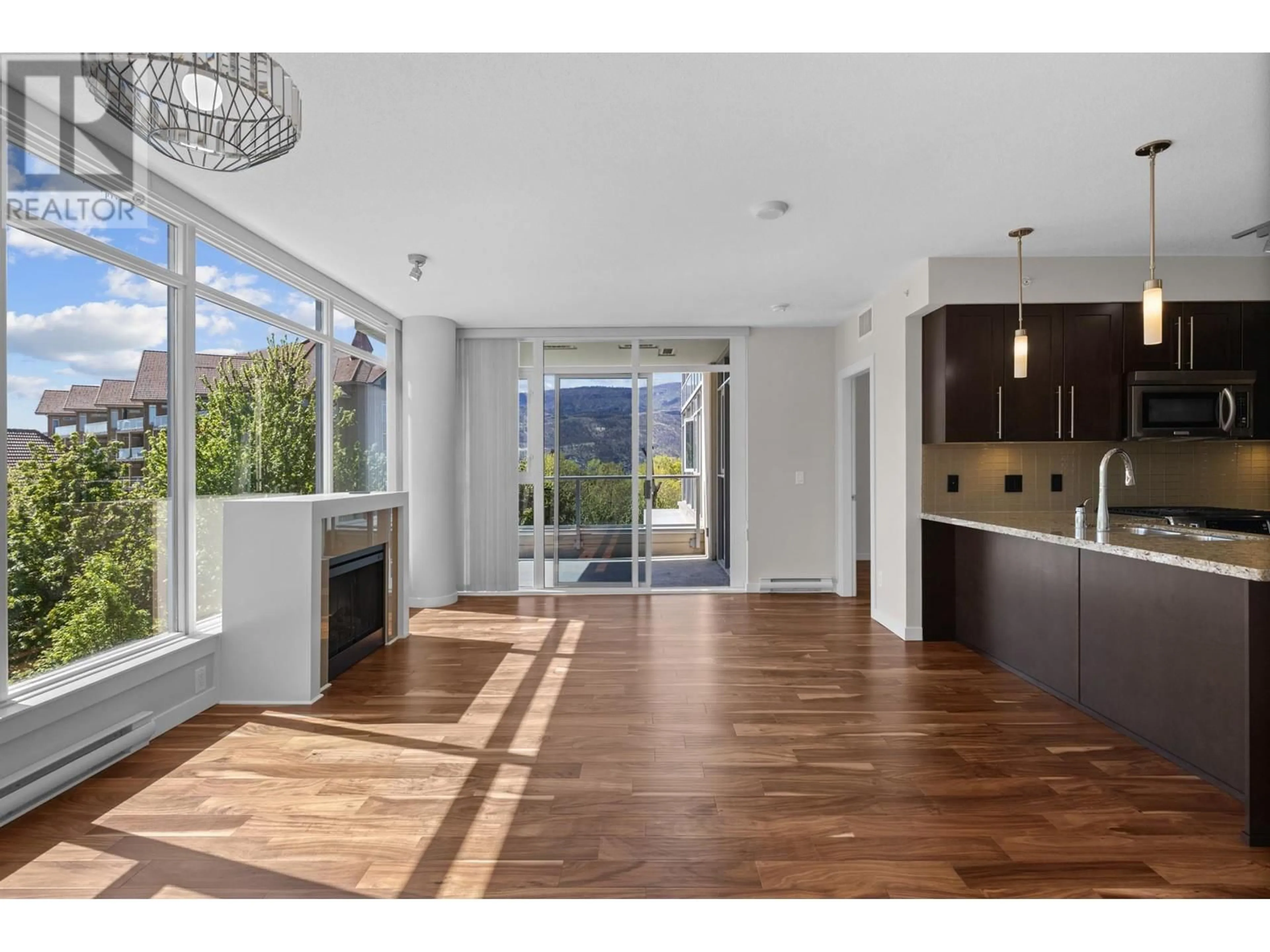 Open concept kitchen, wood/laminate floor for 407 - 1075 SUNSET DRIVE, Kelowna British Columbia V1Y9Y9