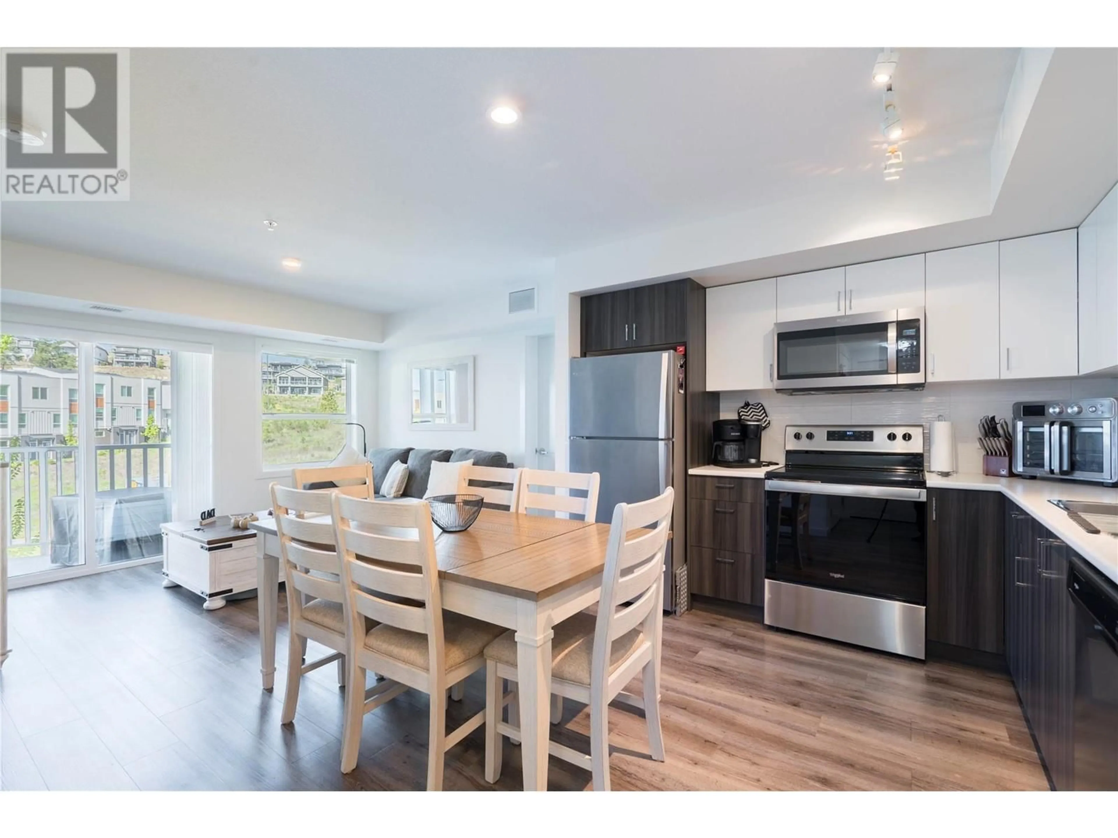 Open concept kitchen, wood/laminate floor for 210 - 625 ACADEMY WAY, Kelowna British Columbia V1V0E3