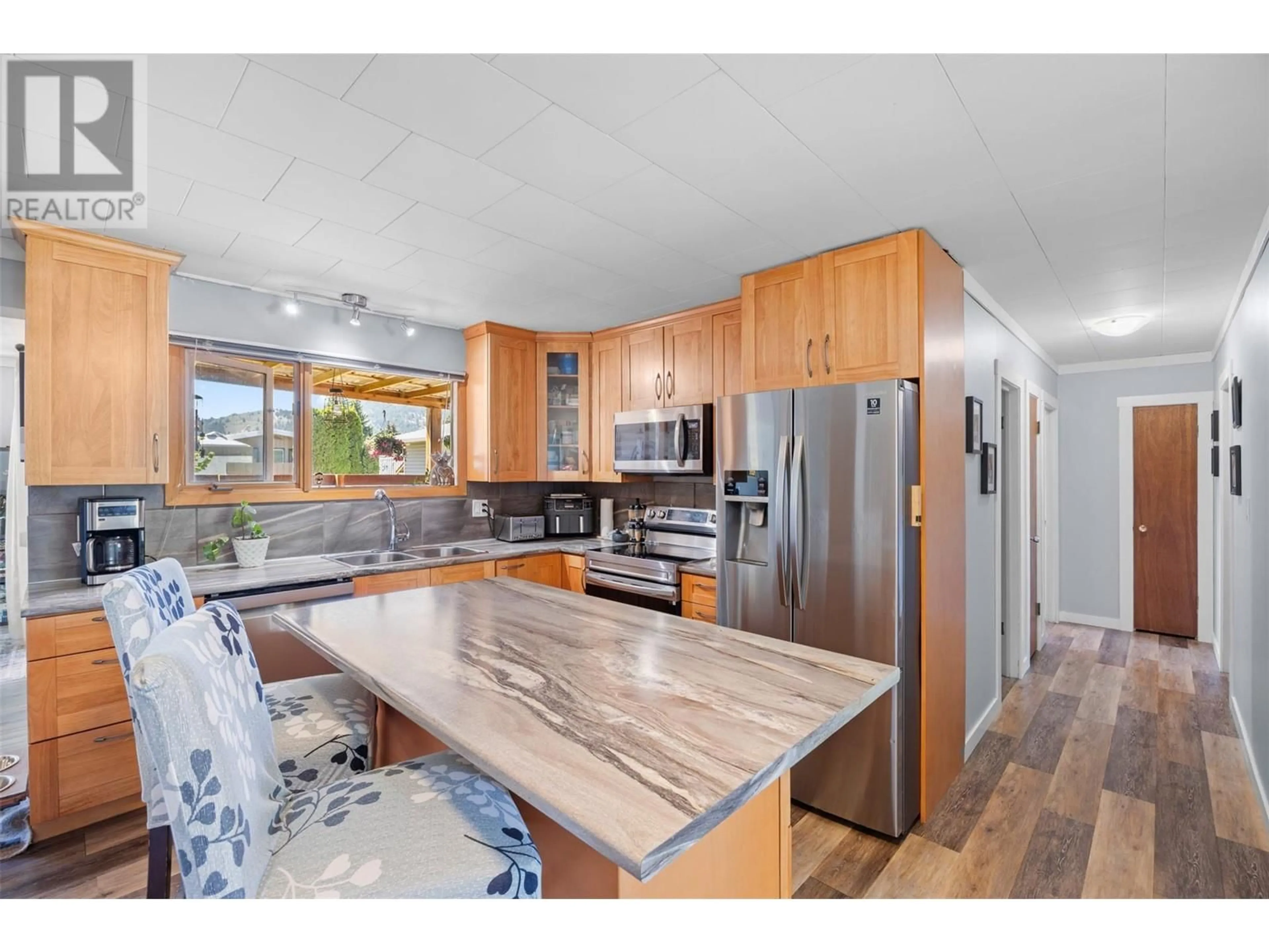 Open concept kitchen, wood/laminate floor for 11109 BARCLAY STREET, Summerland British Columbia V0H1Z0