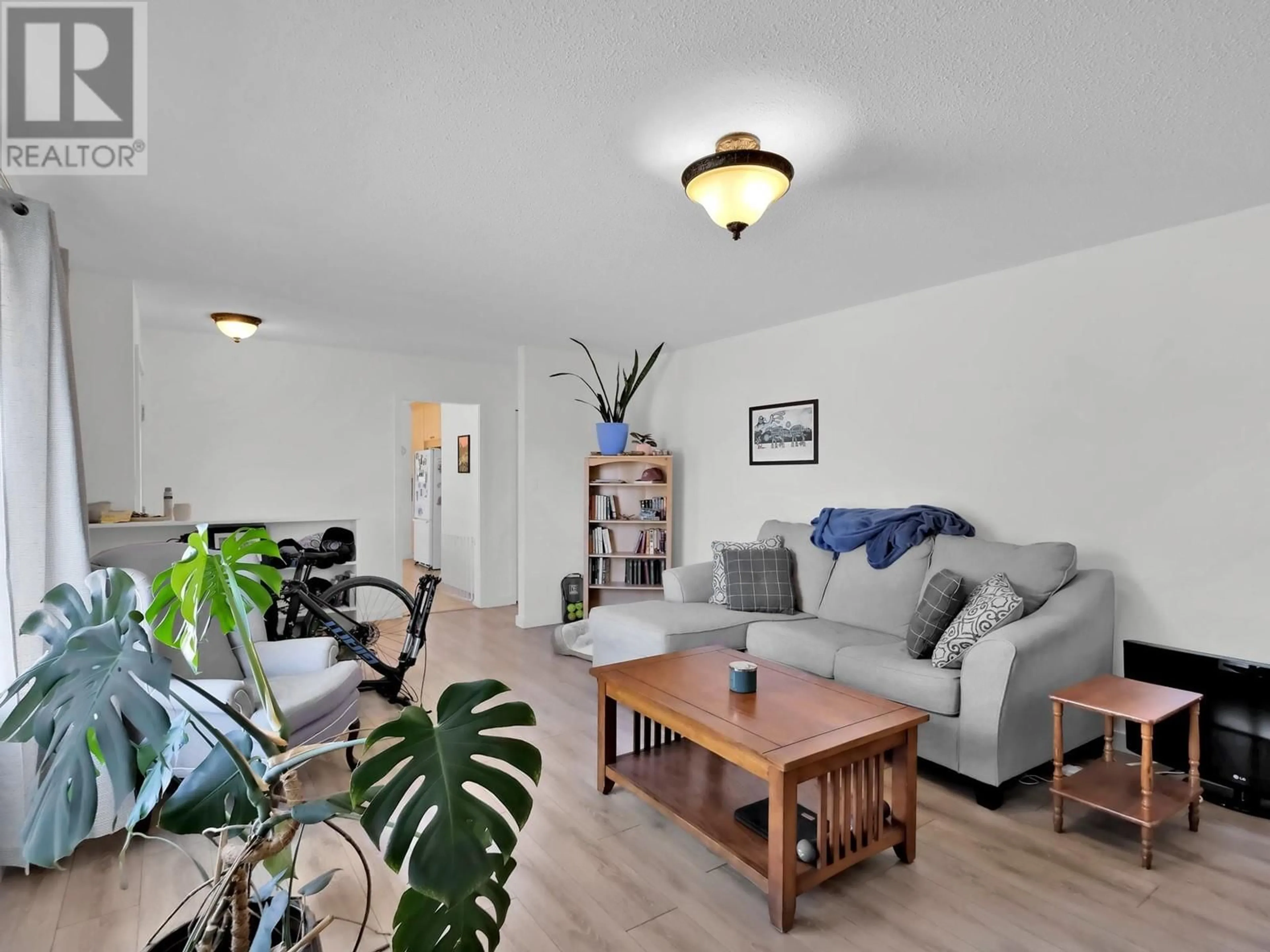 Living room with furniture, wood/laminate floor for 1482 COLUMBIA STREET, Penticton British Columbia V2A3X8