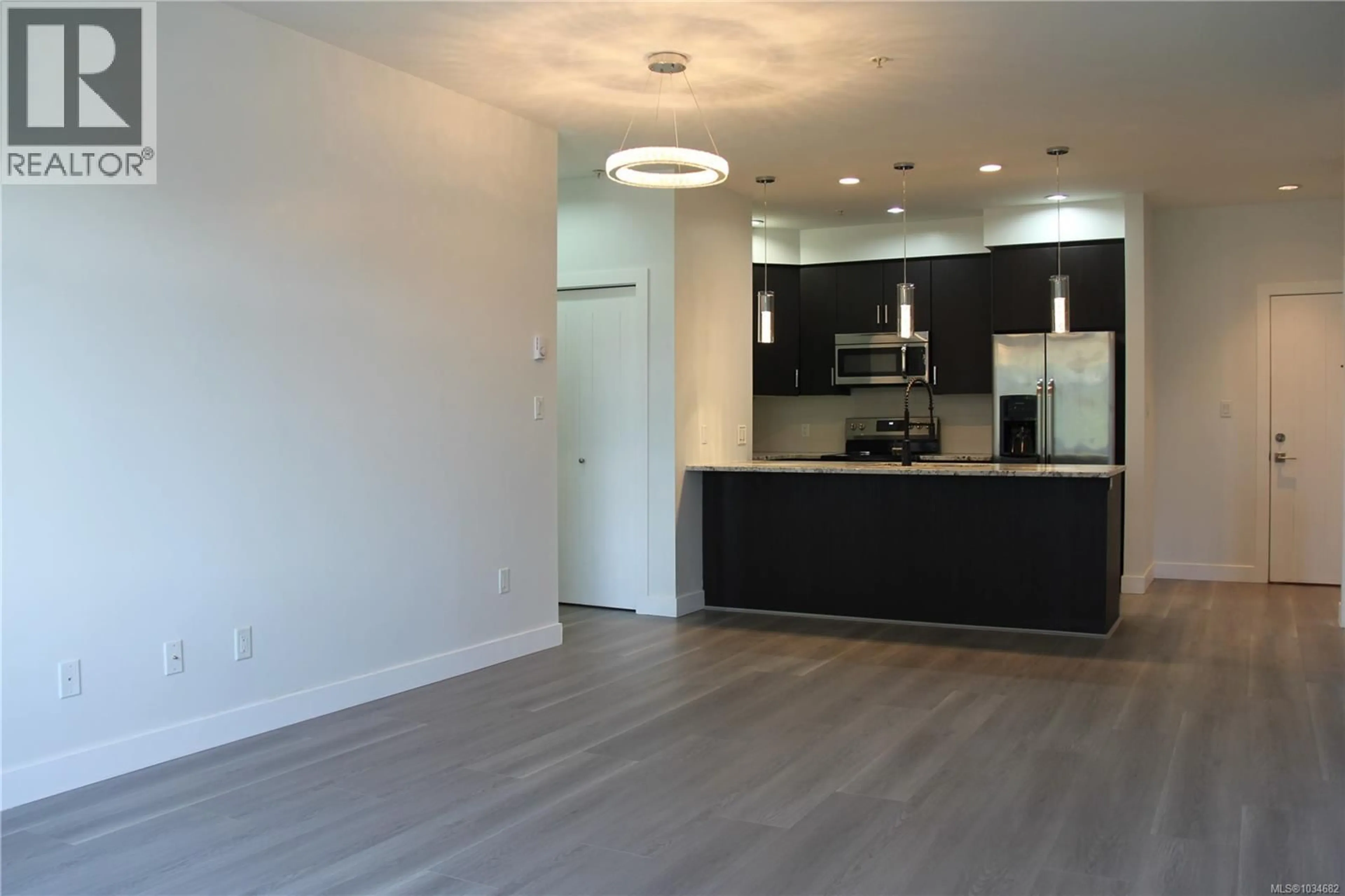 Open concept kitchen, wood/laminate floor for 312 - 2655 SOOKE ROAD, Langford British Columbia V9B1Y3