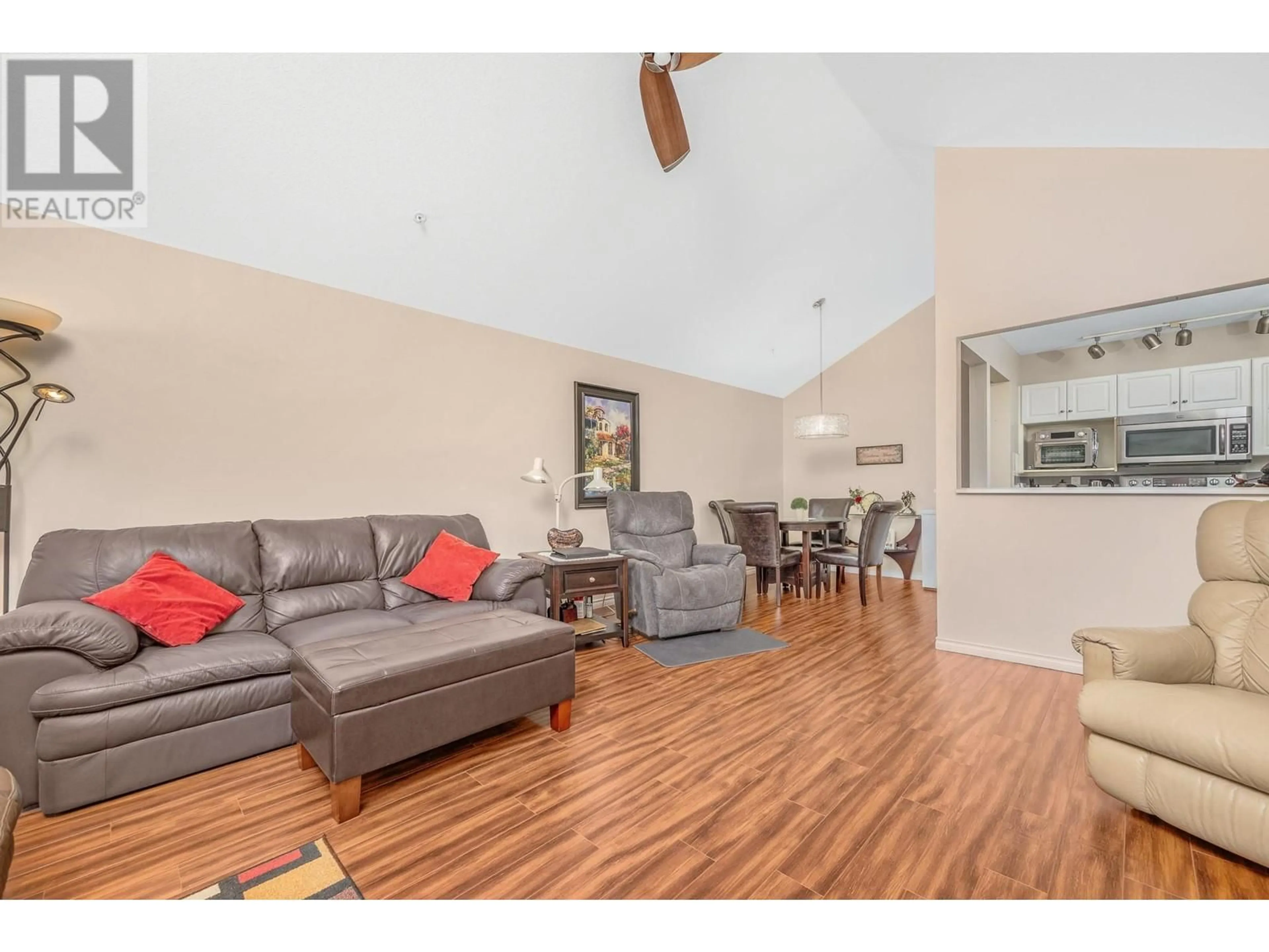 Living room with furniture, wood/laminate floor for 401 - 3301 CENTENNIAL DRIVE, Vernon British Columbia V1T2T8