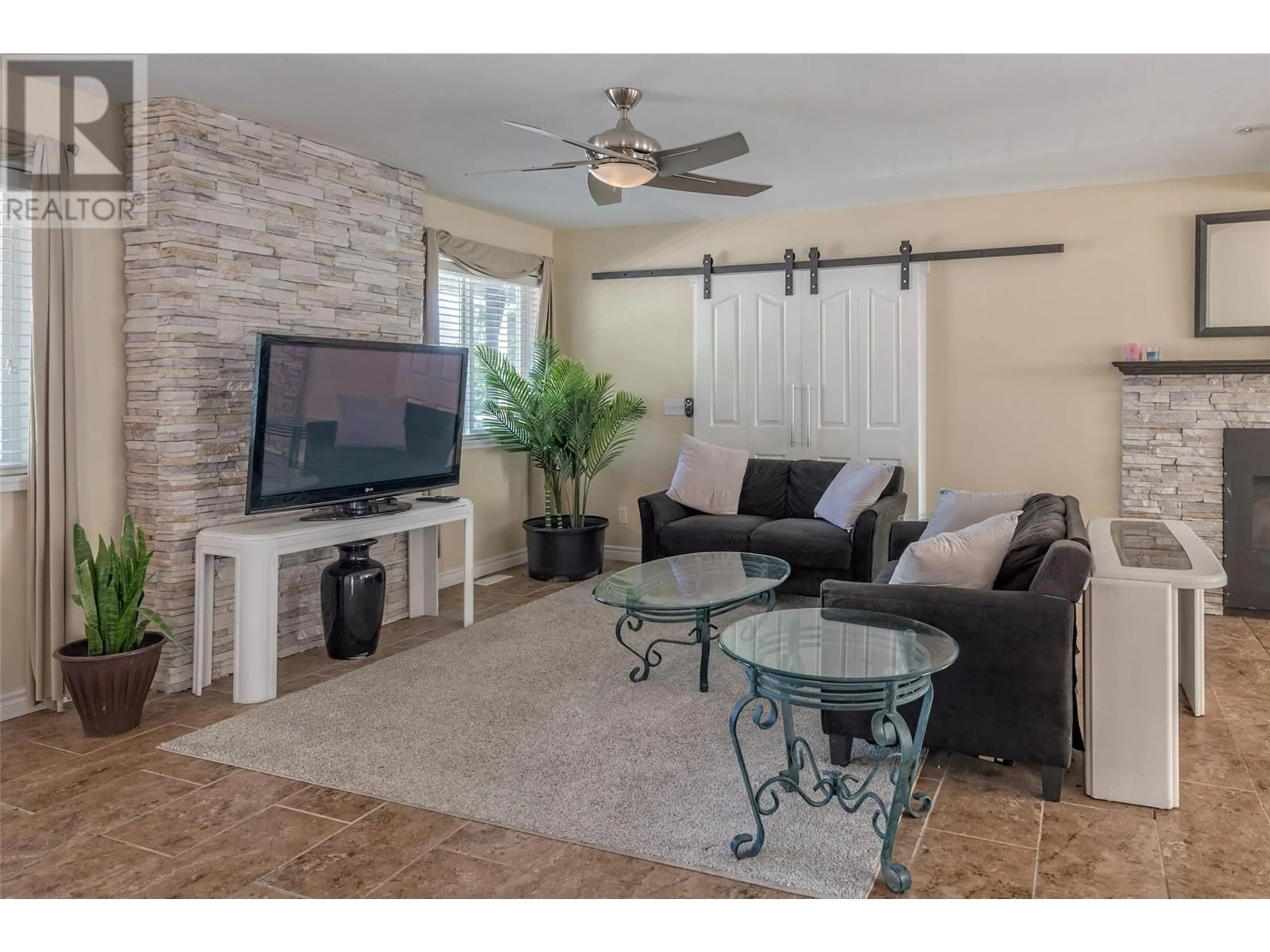 Living room with furniture, ceramic/tile floor for 10718 PINECREST ROAD, Vernon British Columbia V1H2C1