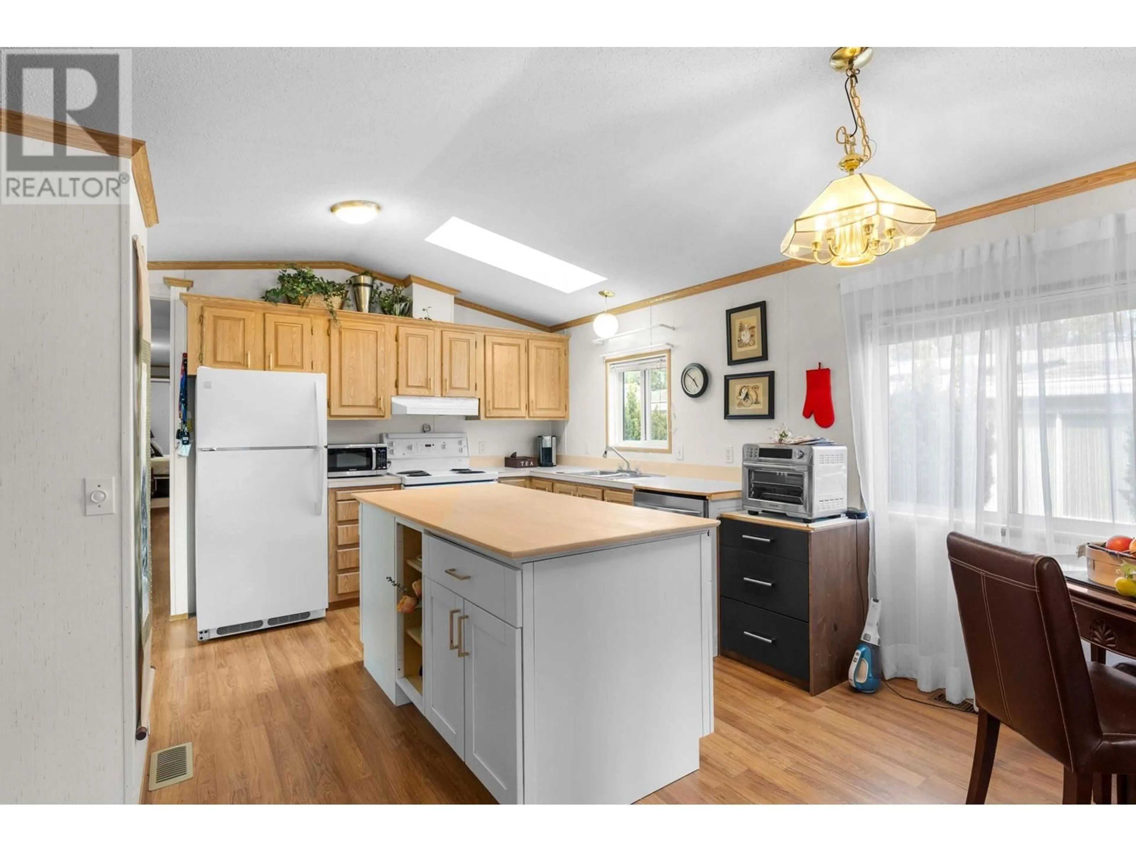 Open concept kitchen, wood/laminate floor for #97 1850 SHANNON LAKE ROAD, Kelowna British Columbia V4T1L6