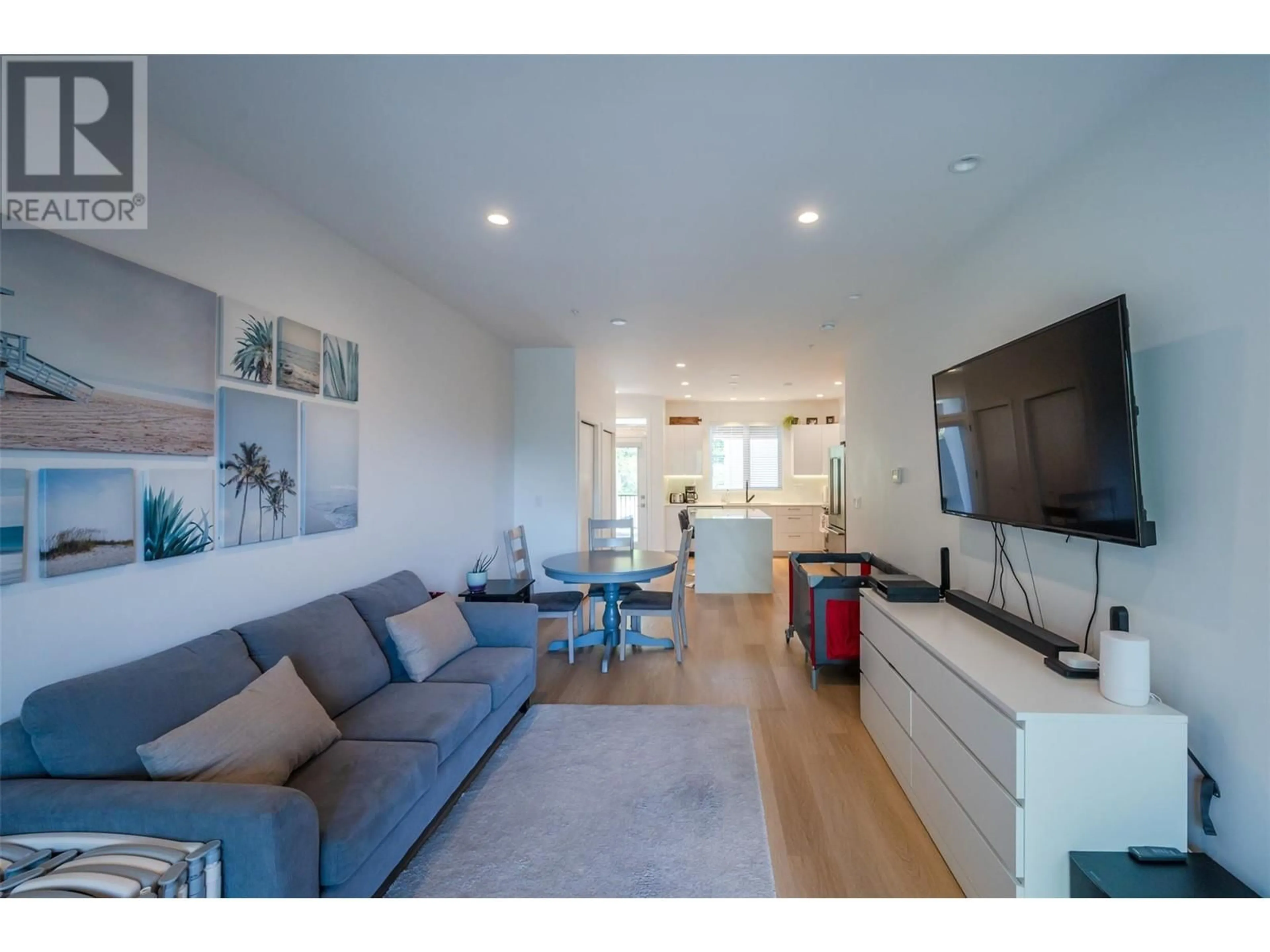 Living room with furniture, wood/laminate floor for 107 - 555 WADE AVENUE EAST, Penticton British Columbia V2A1T3