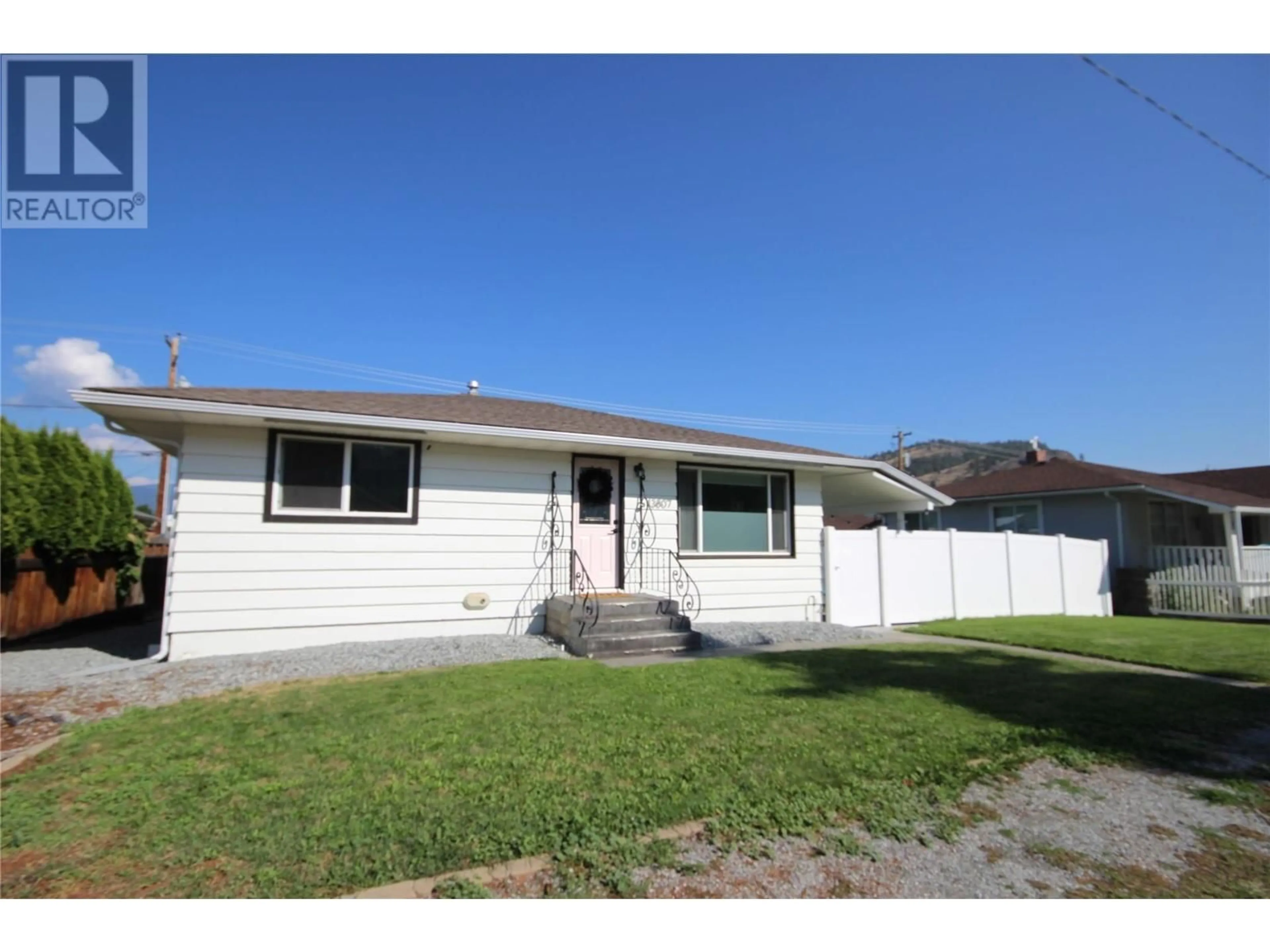 Home with vinyl exterior material, street for 13807 SPENCER AVENUE, Summerland British Columbia V0H1Z0
