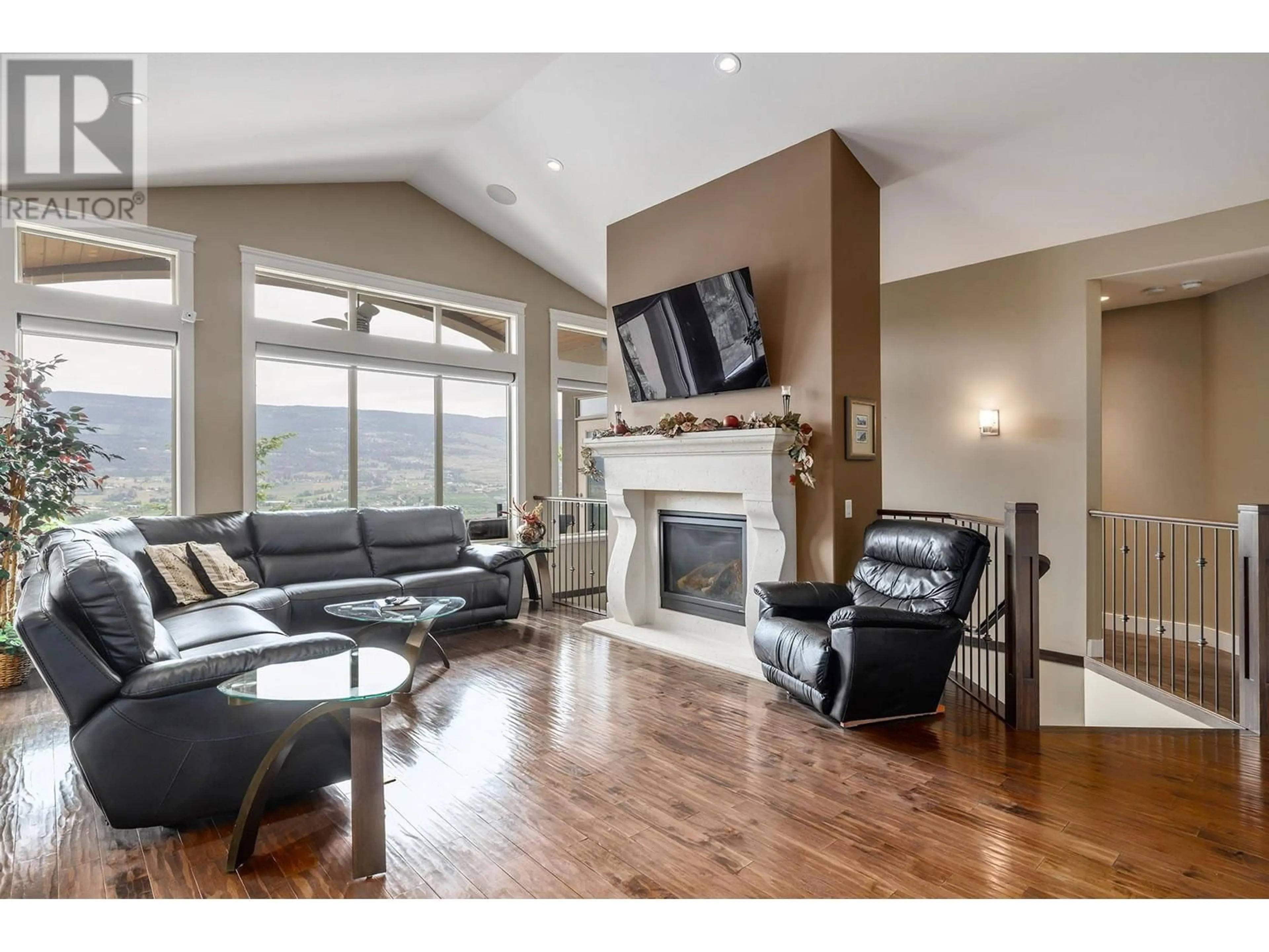 Living room with furniture, wood/laminate floor for 1821 CAPISTRANO DRIVE, Kelowna British Columbia V1V2Z3