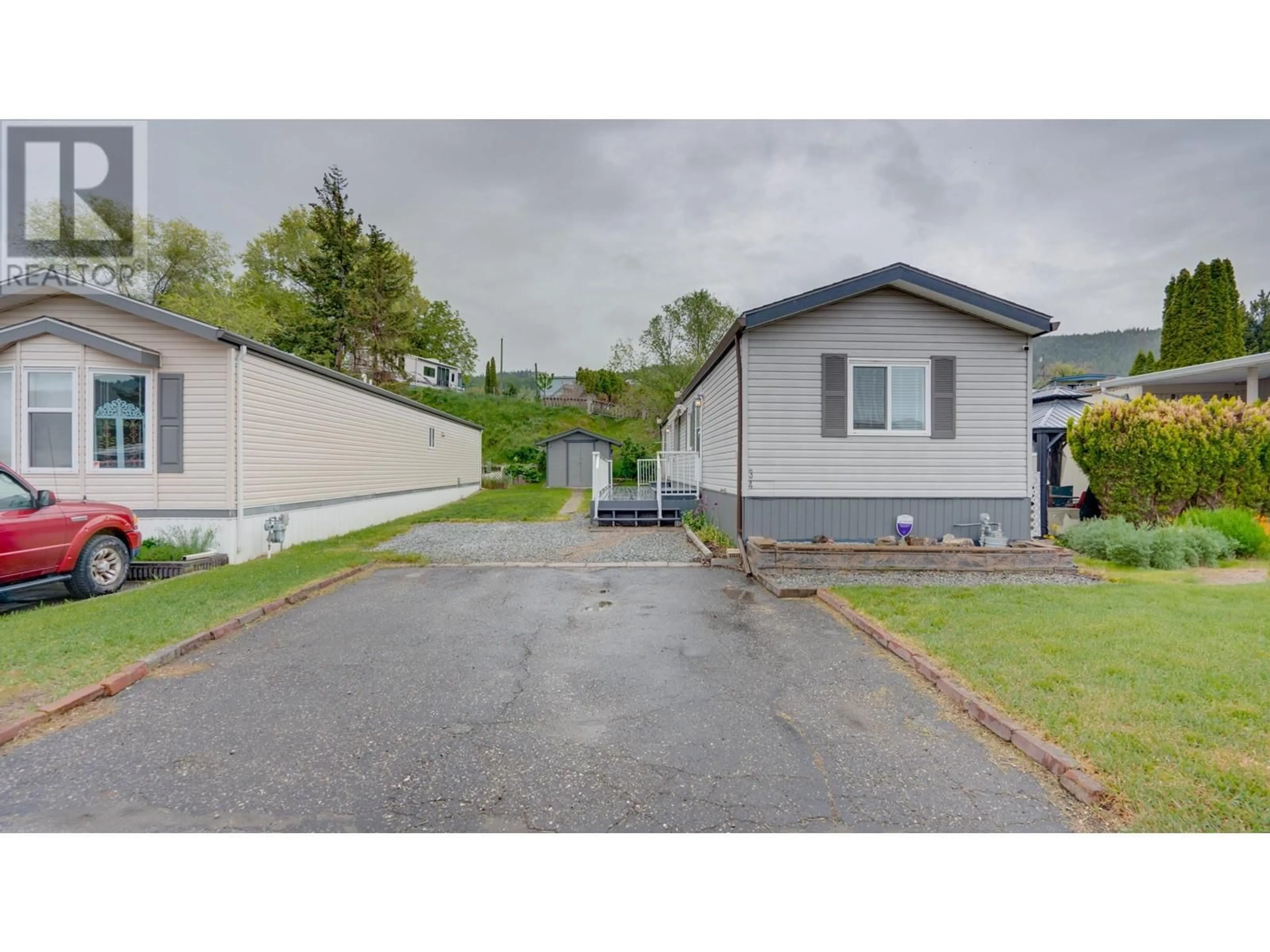 A pic from outside/outdoor area/front of a property/back of a property/a pic from drone, street for 34 - 6902 OKANAGAN LANDING ROAD, Vernon British Columbia V1H1X4