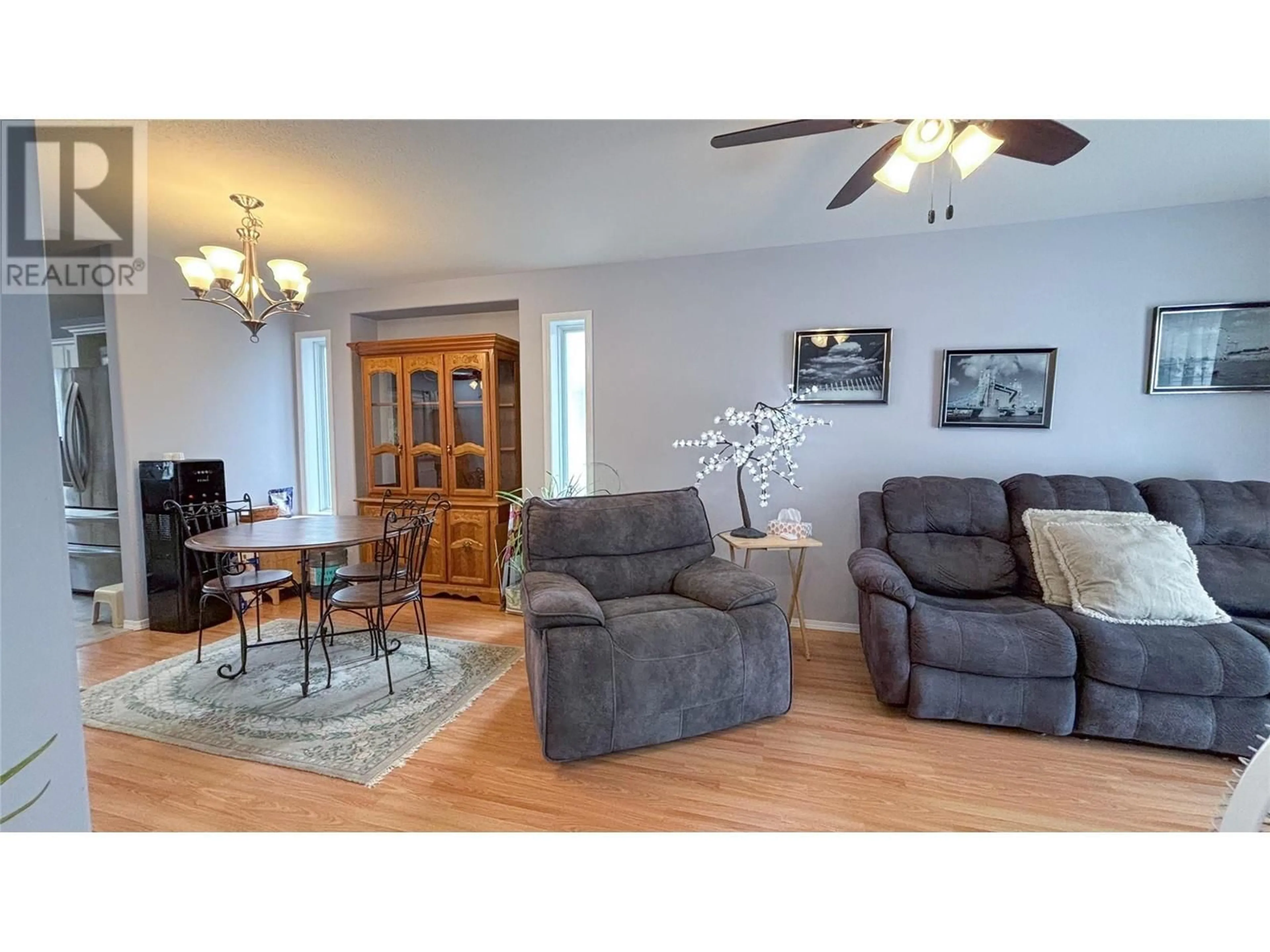 Living room with furniture, wood/laminate floor for 512 RED WING DRIVE, Penticton British Columbia V2A8K6