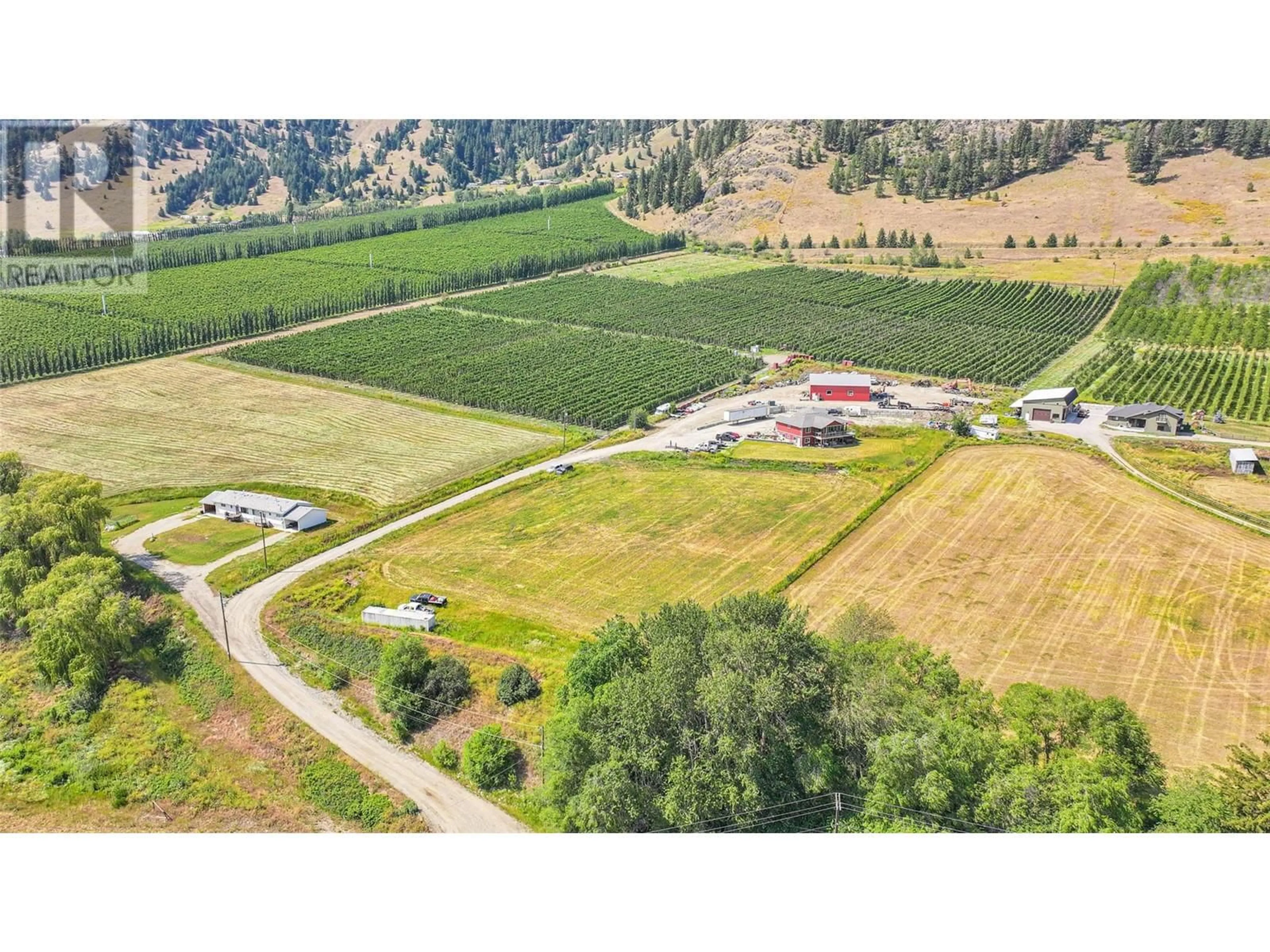 A pic from outside/outdoor area/front of a property/back of a property/a pic from drone, mountain view for 6205 6 HIGHWAY, Coldstream British Columbia V1B3C7