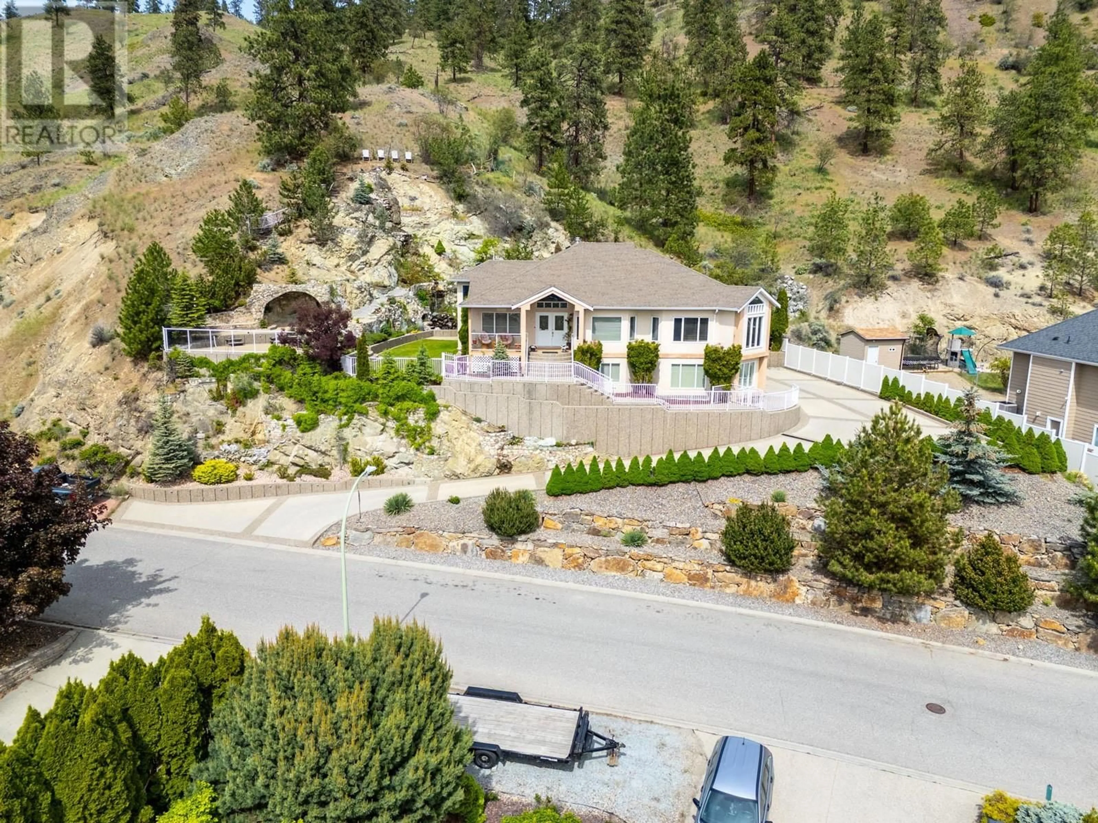 A pic from outside/outdoor area/front of a property/back of a property/a pic from drone, mountain view for 705 ROYAL PINE DRIVE, Kelowna British Columbia V1Y9G2