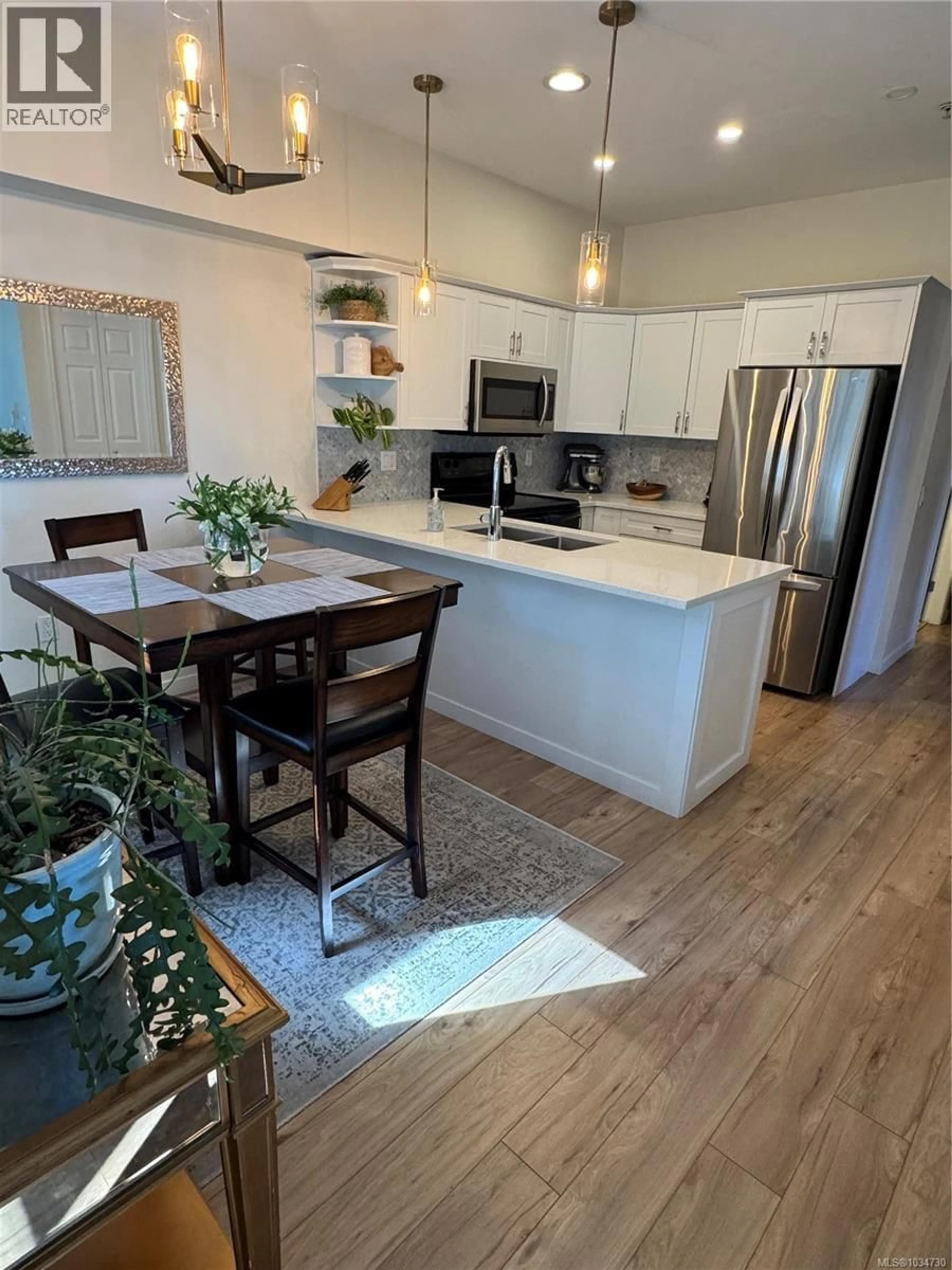 Open concept kitchen, wood/laminate floor for 409 - 360 GOLDSTREAM AVENUE, Colwood British Columbia V9B2W3