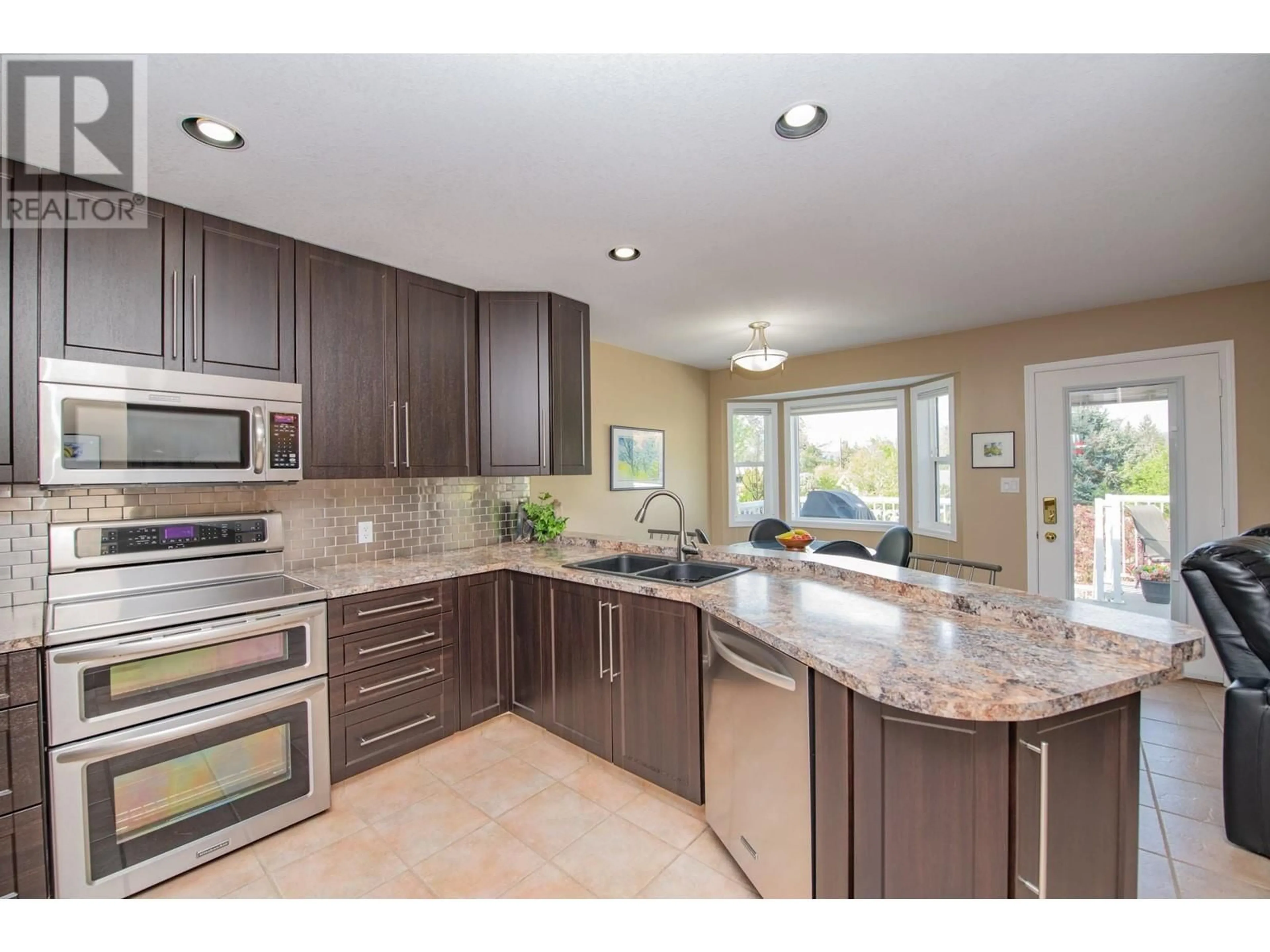 Open concept kitchen, ceramic/tile floor for 2279 CATT AVENUE, Lumby British Columbia V0E2G0