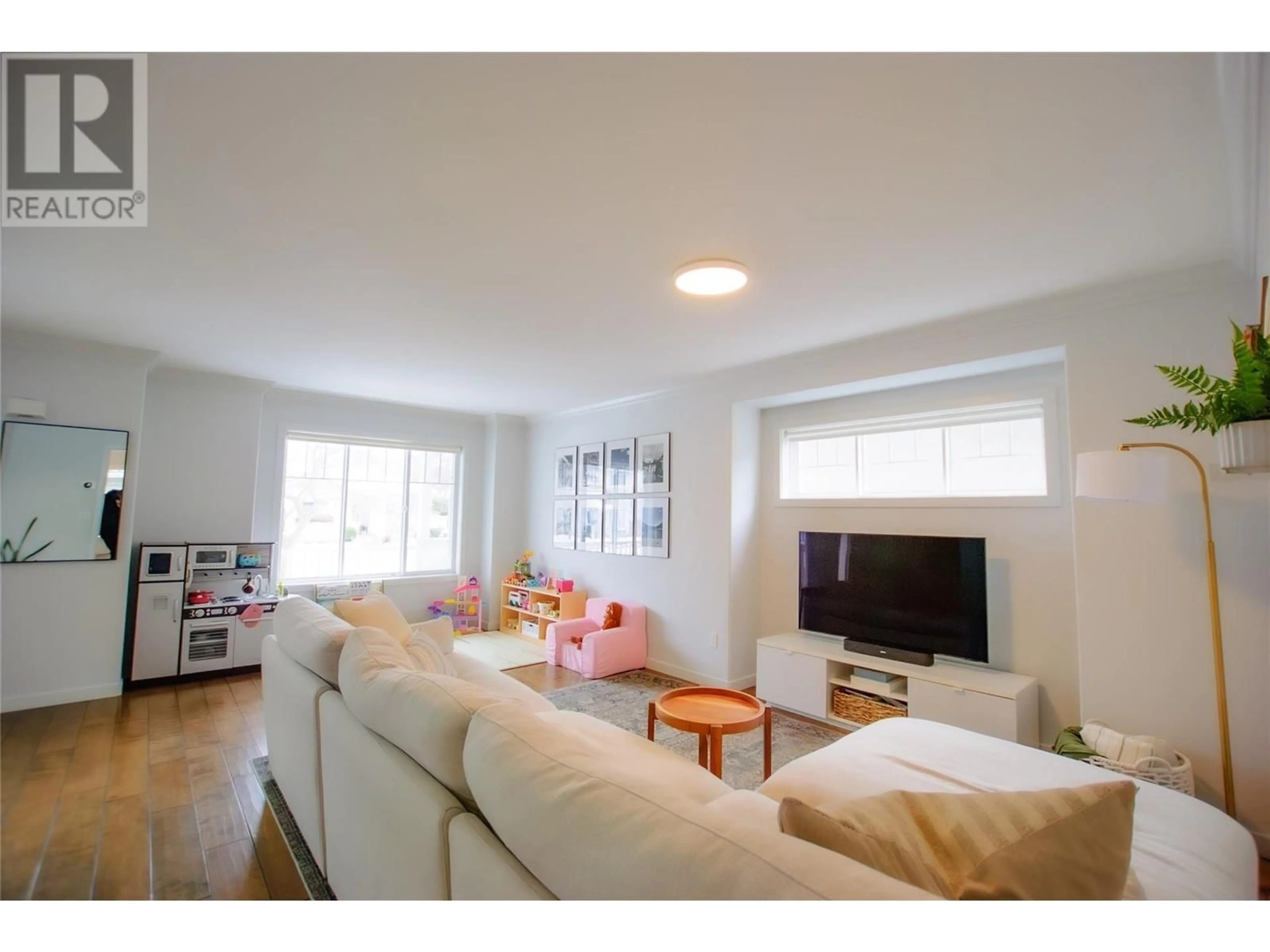 Living room with furniture, wood/laminate floor for 104 - 665 COOK ROAD, Kelowna British Columbia V1W4T4