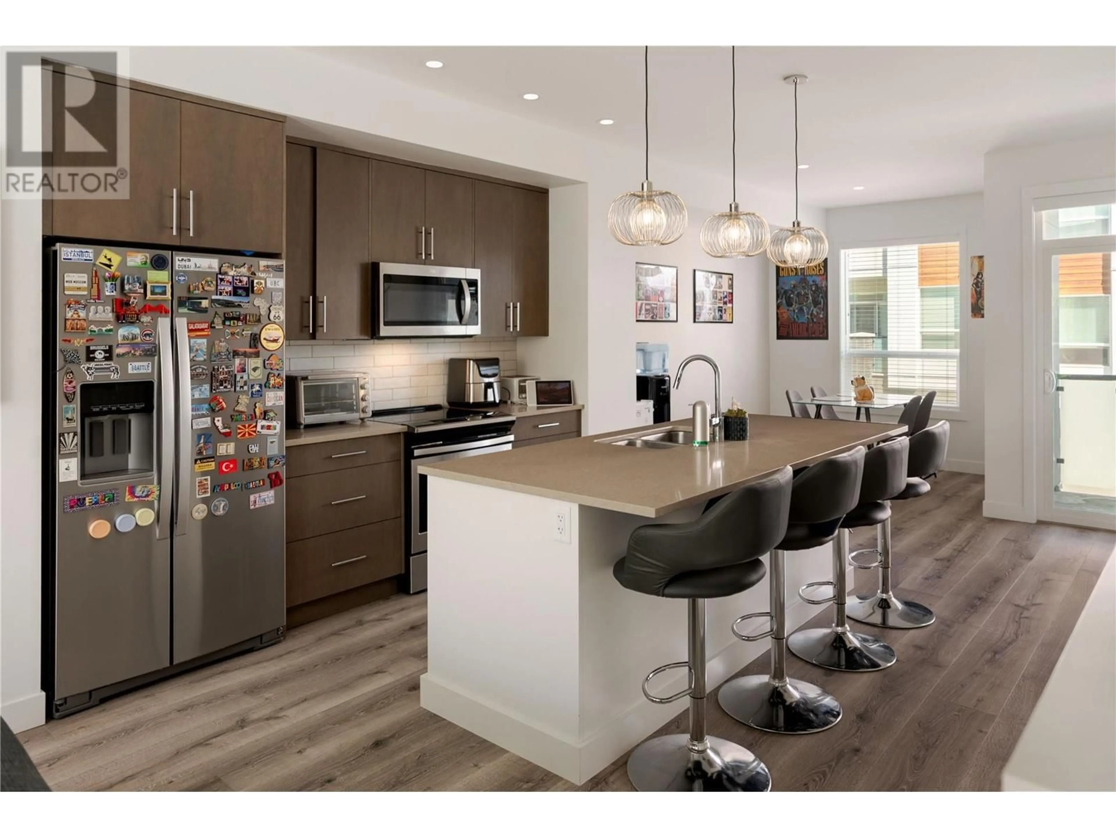 Open concept kitchen, wood/laminate floor for 7 - 610 ACADEMY WAY, Kelowna British Columbia V1V0E8