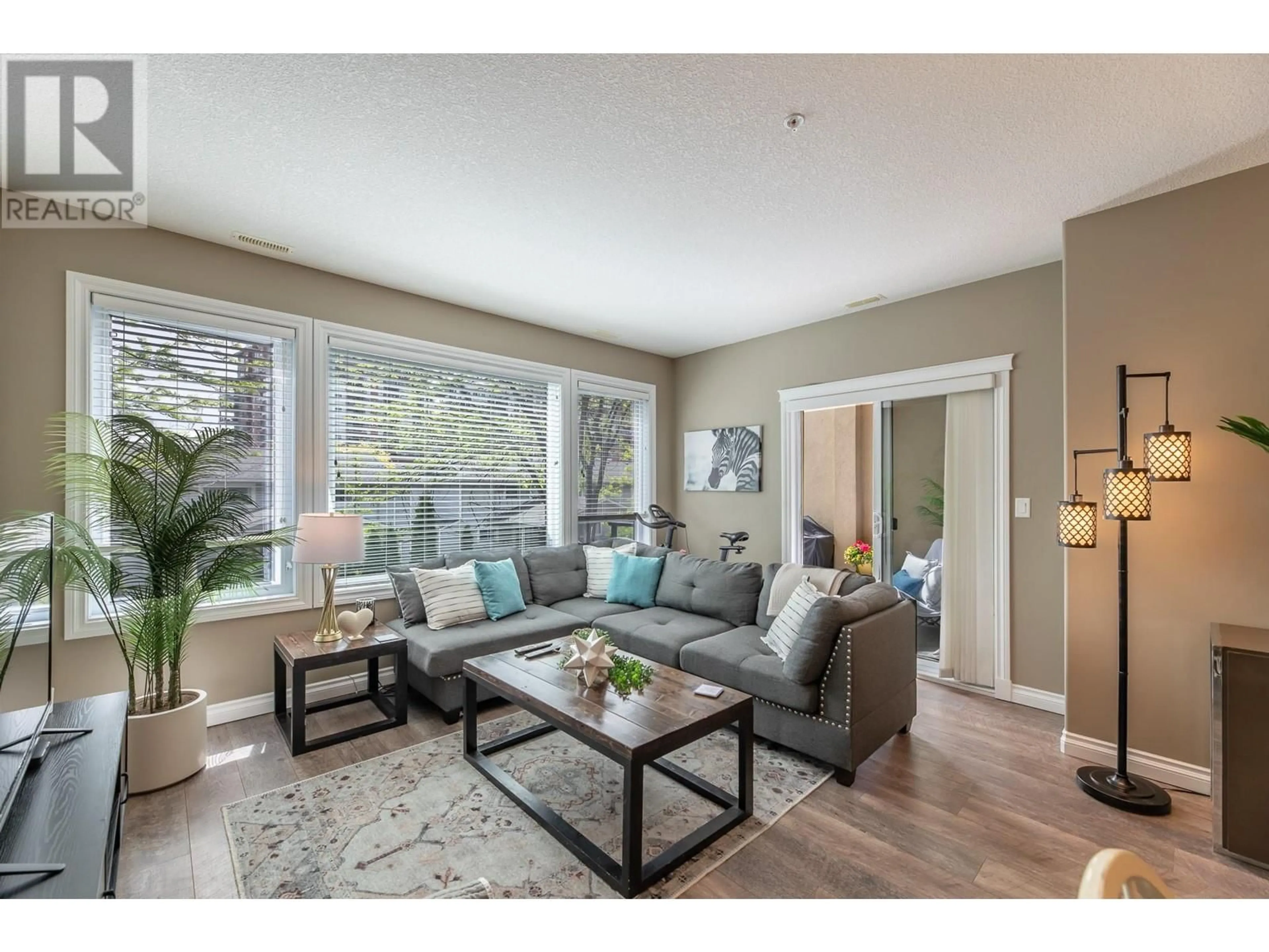 Living room with furniture, wood/laminate floor for 209 - 3313 WILSON STREET, Penticton British Columbia V2A8J3