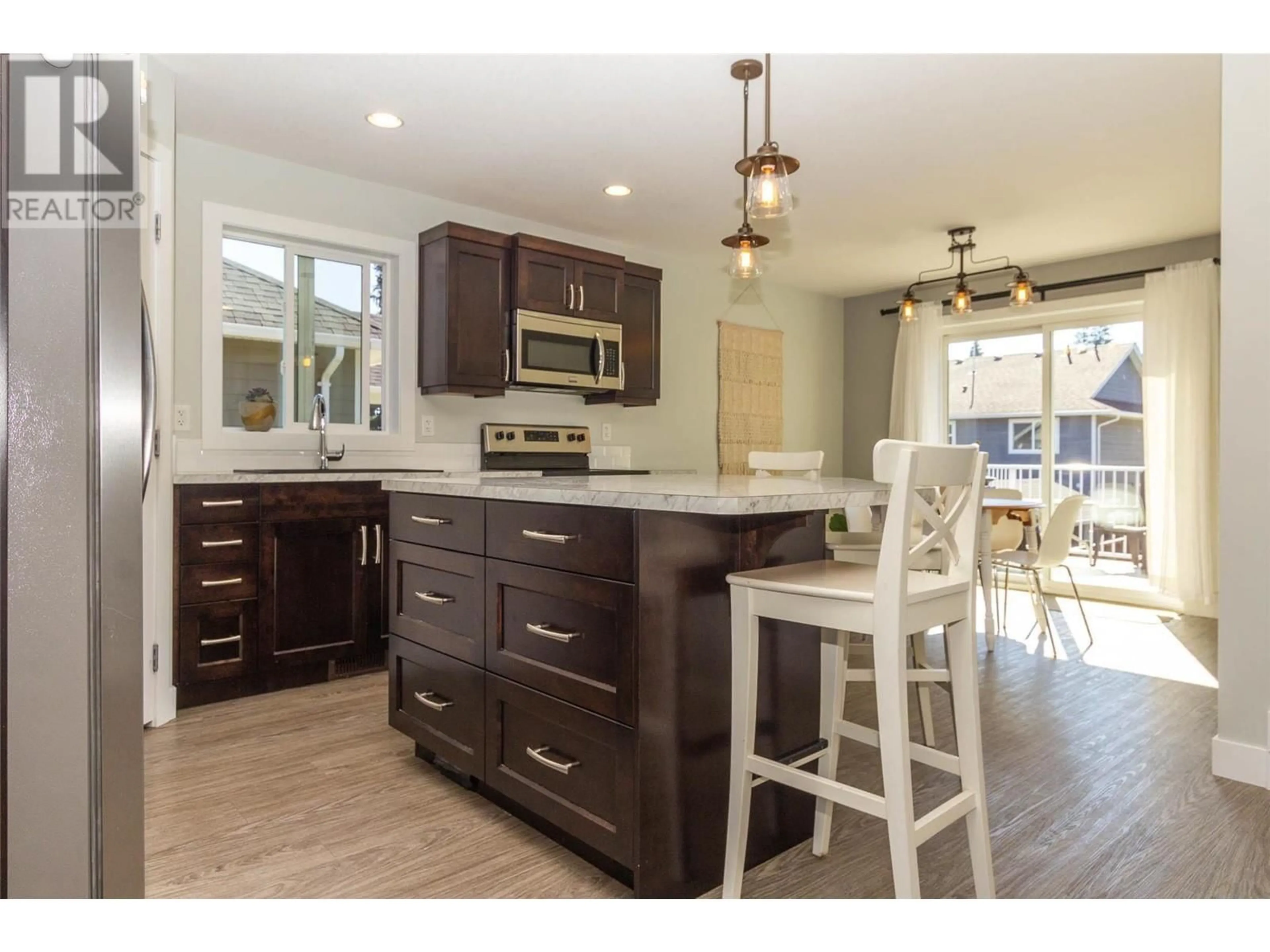 Open concept kitchen, wood/laminate floor for 2368 4B AVENUE SOUTHEAST, Salmon Arm British Columbia V1E1K9